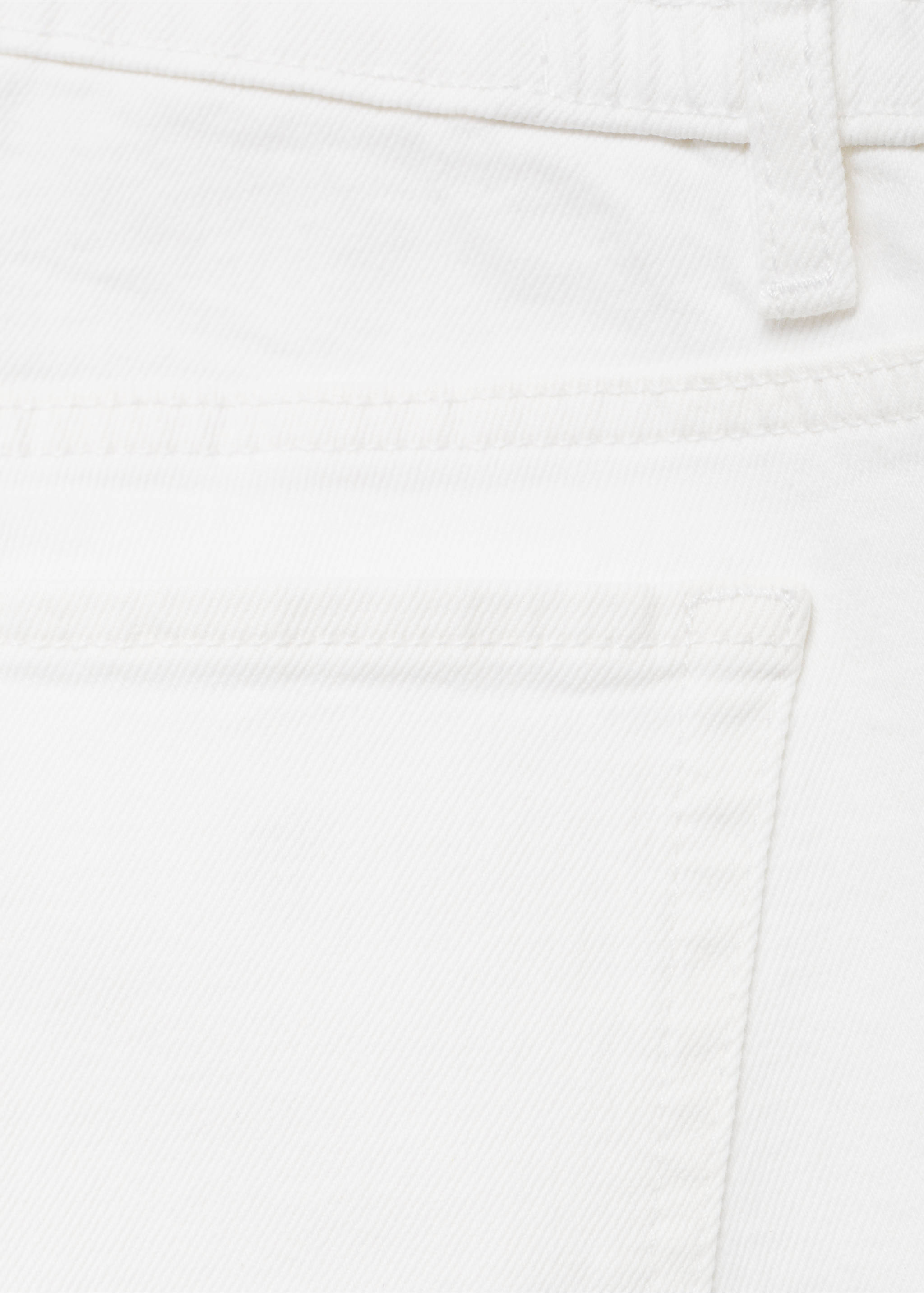 Close-up of white denim trousers showing fabric texture and back pocket detail., White. Ref: 17001242-00.