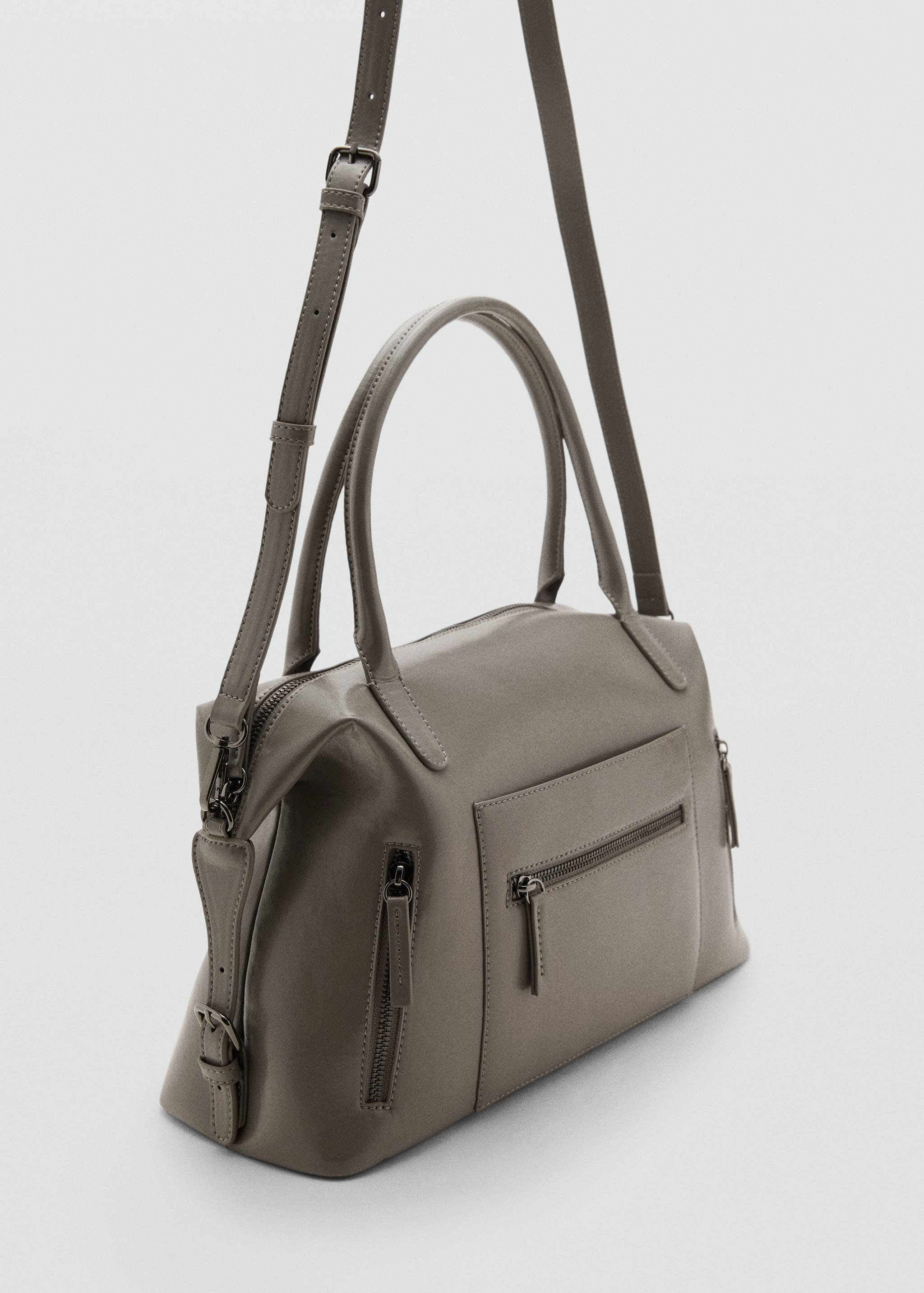 Stor handväska i styvt material - Bild av mittparti