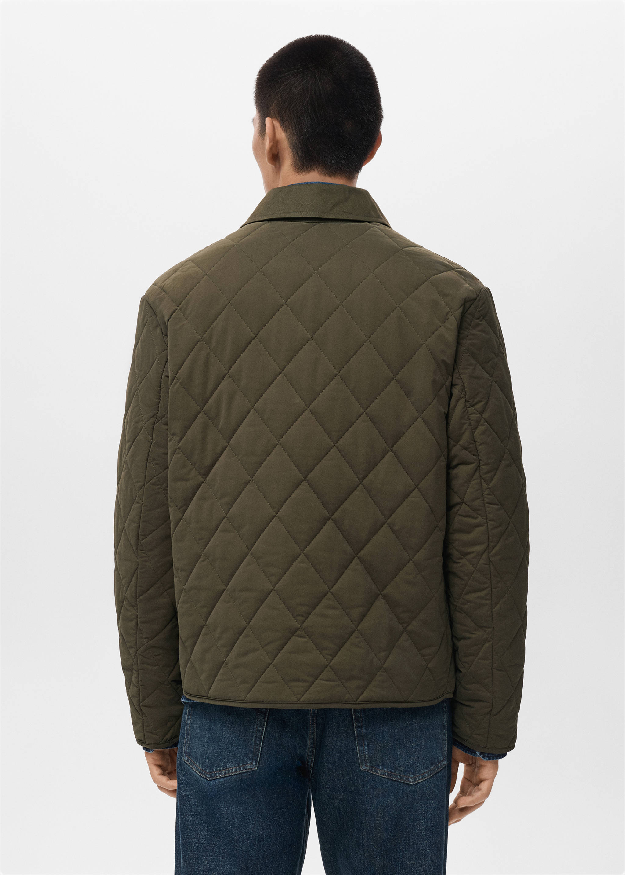 Dark olive green quilted jacket seen from the back.