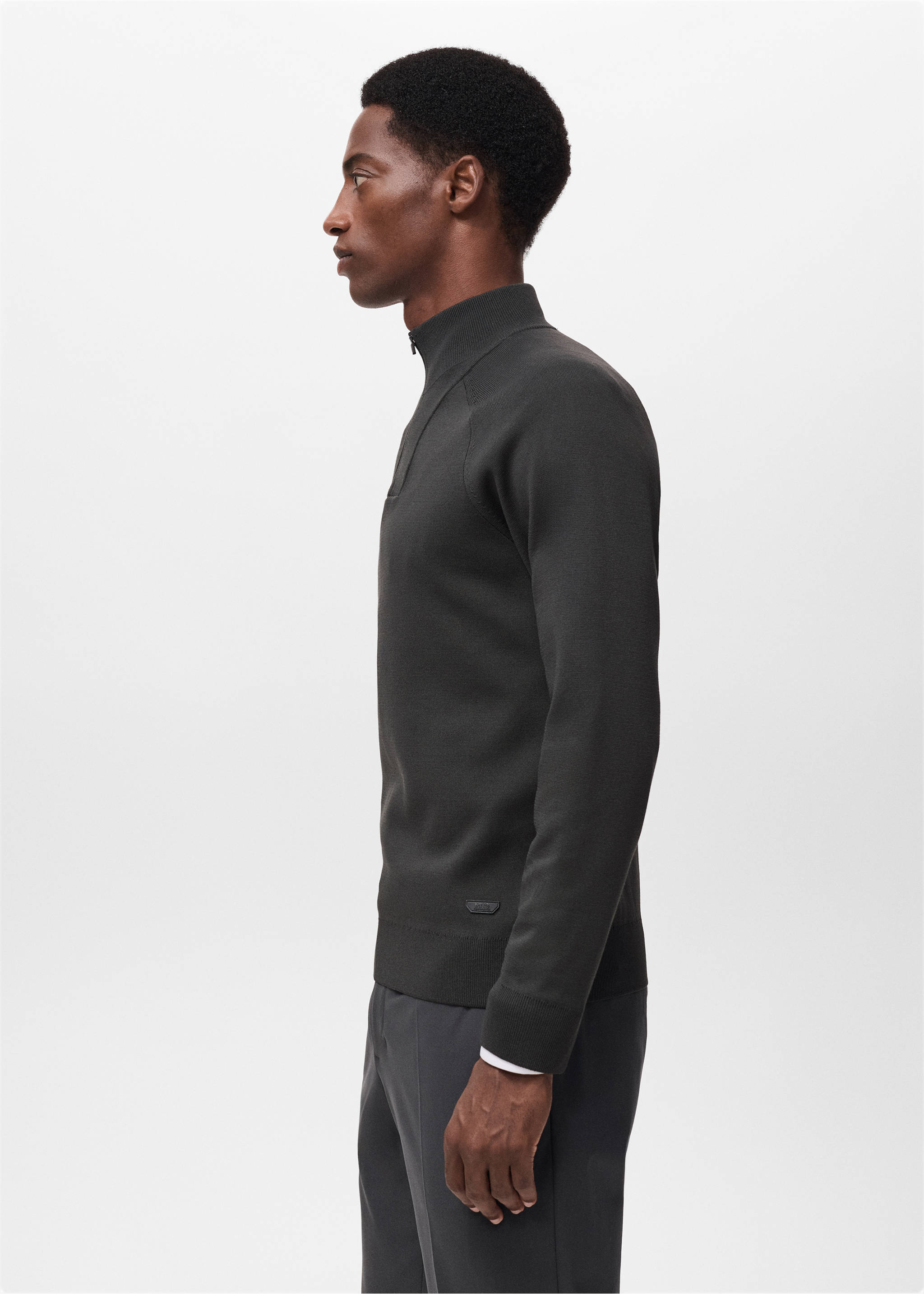 Dark green knit jersey with a zip-up high collar, shown in profile., Dark Green. Ref: 17005979-00.