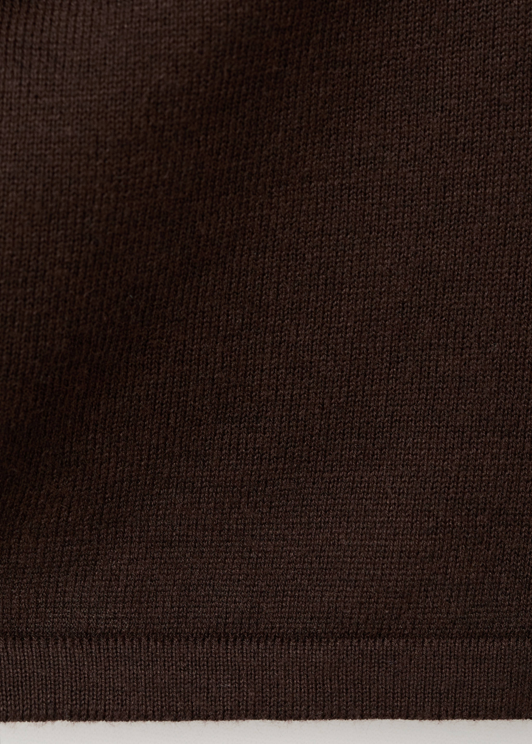 Close-up of the fine knit texture of a dark brown jersey.