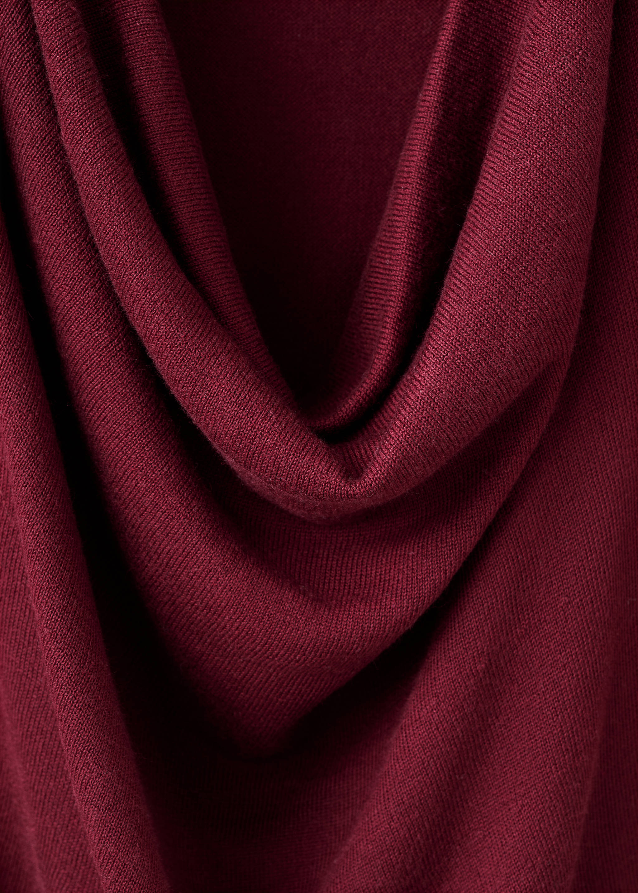 Close-up of a burgundy knit jersey with a draped cowl neckline.