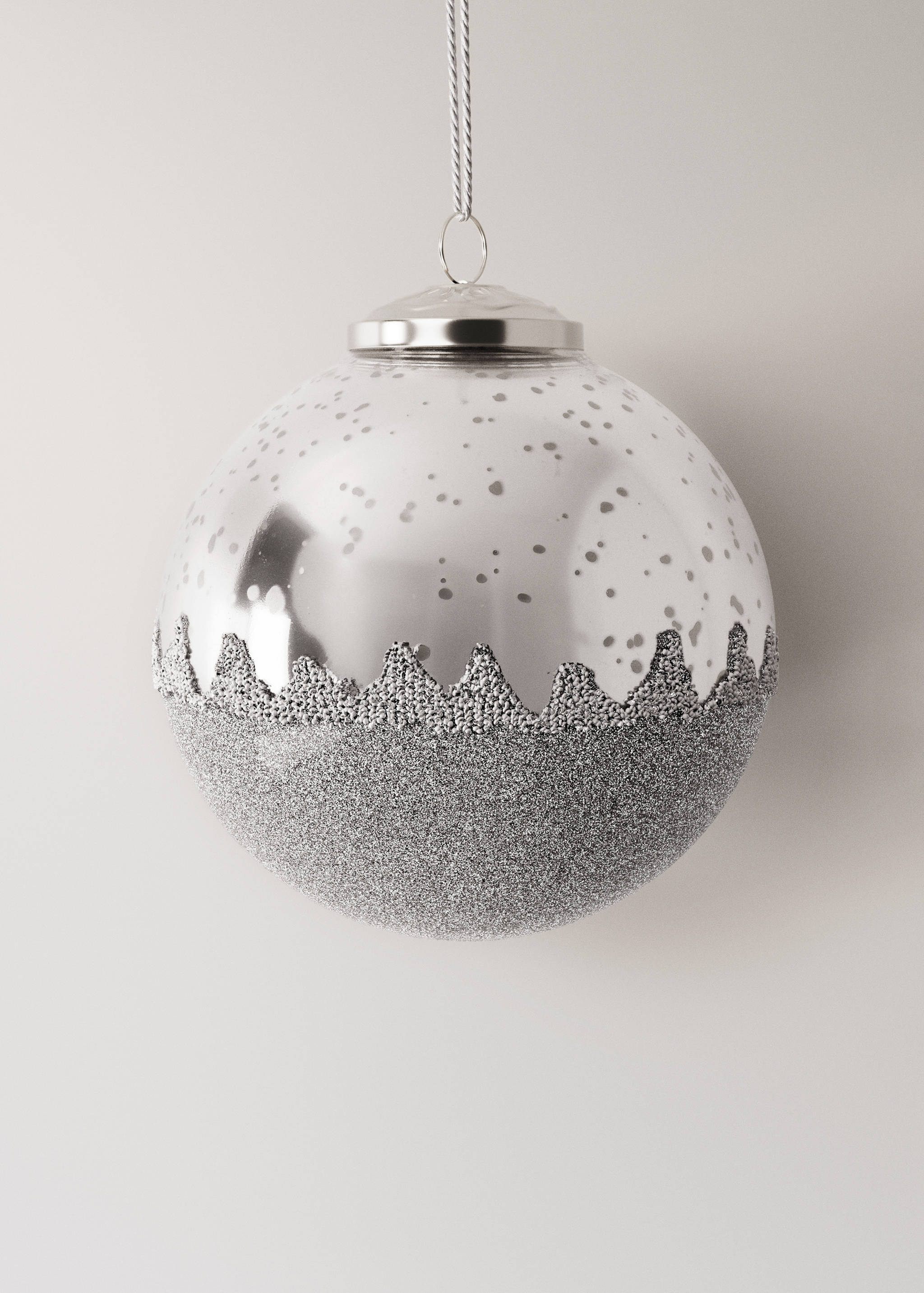 Silver glitter Christmas bauble with a speckled reflective top and hanging cord.