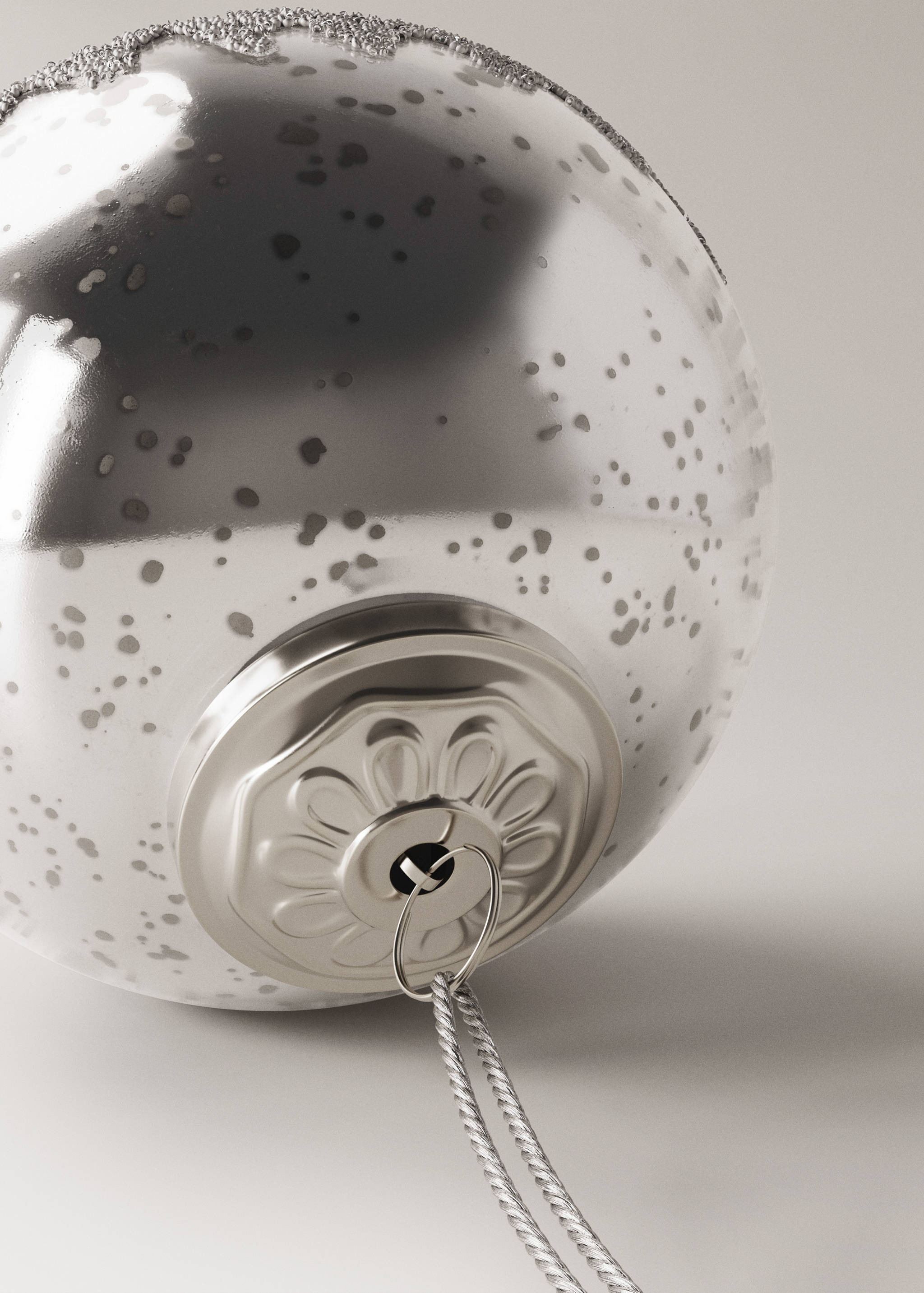 Silver speckled Christmas bauble with a decorative cap and glitter detail.