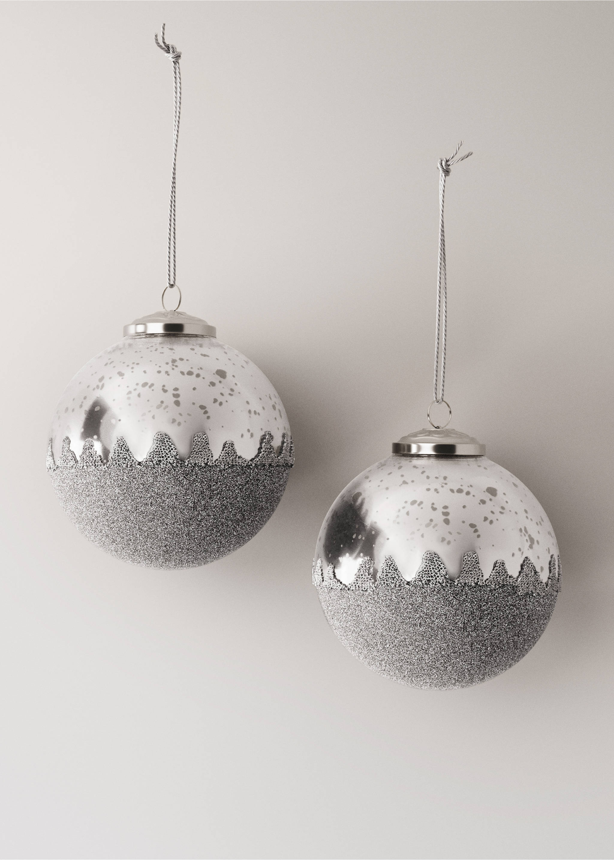 Two silver Christmas ornaments with speckled and glittery lower halves., Silver. Ref: 17008639-00.