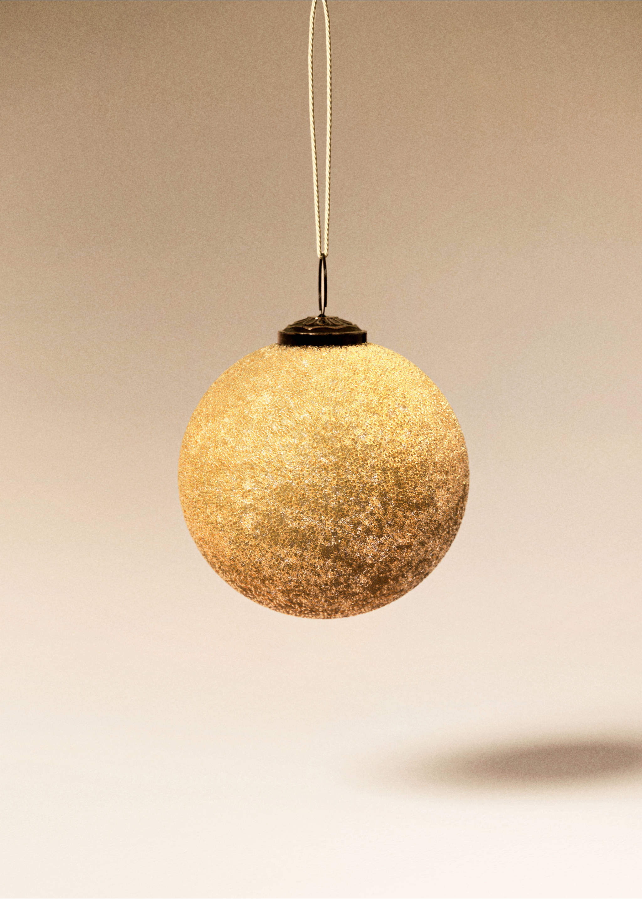 Textured gold spherical Christmas ornament with a hanging cord., Gold. Ref: 17008640-00.