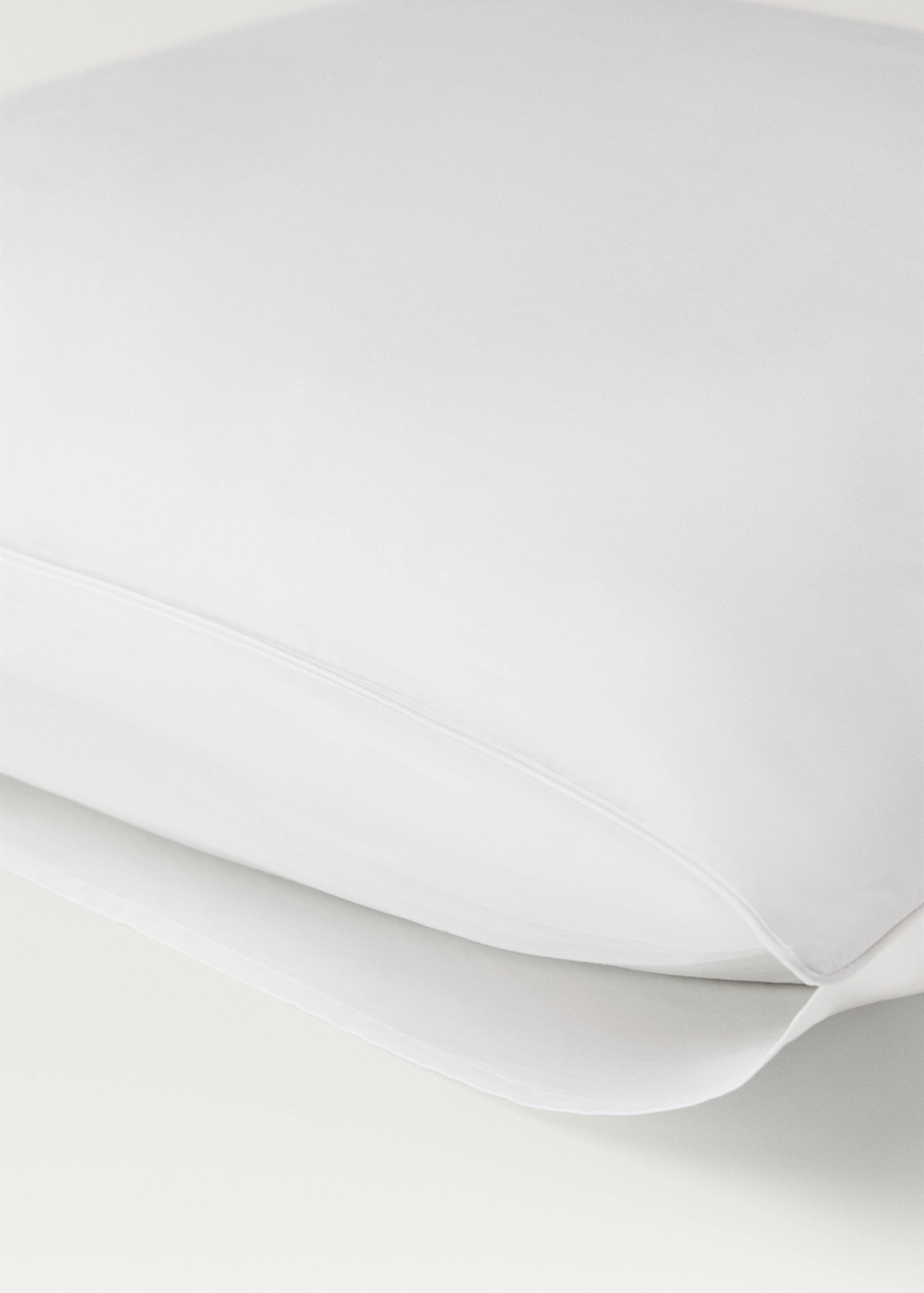 Plain white pillowcase with a detailed piped edge.