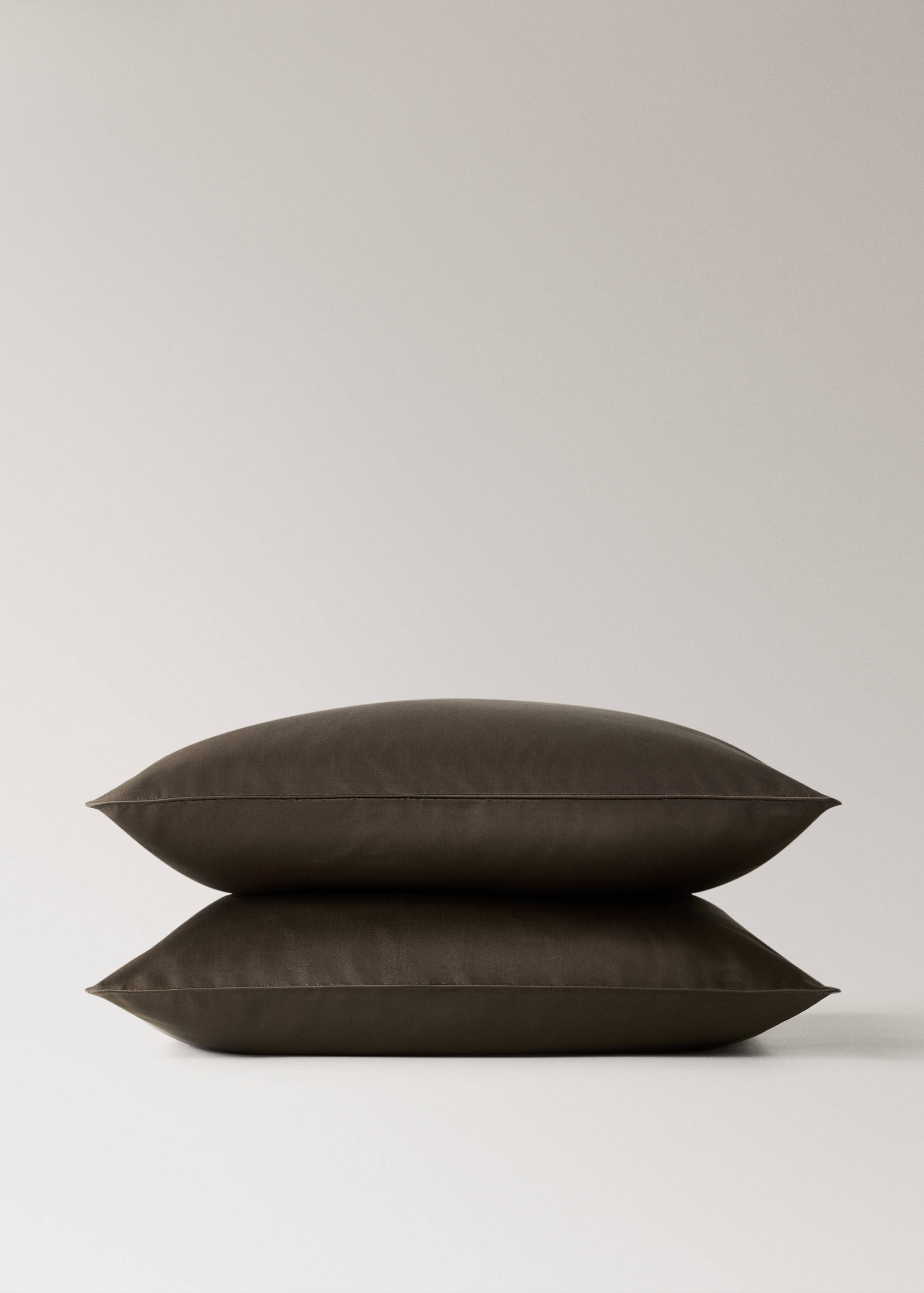 Dark brown pillowcase stack.