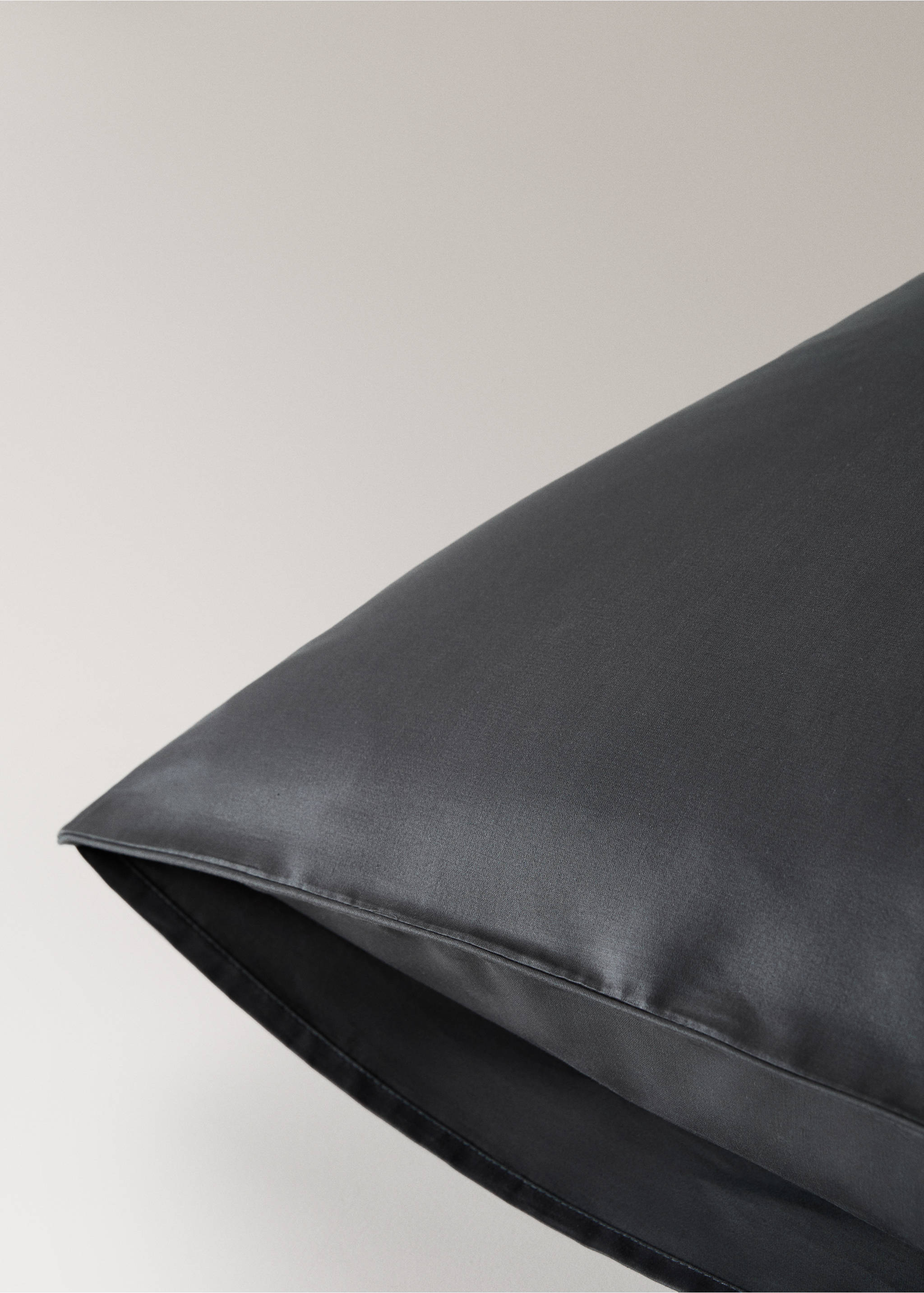 Dark grey pillowcase detail showing smooth fabric and stitched edges., Dark Grey. Ref: 17011584-00.