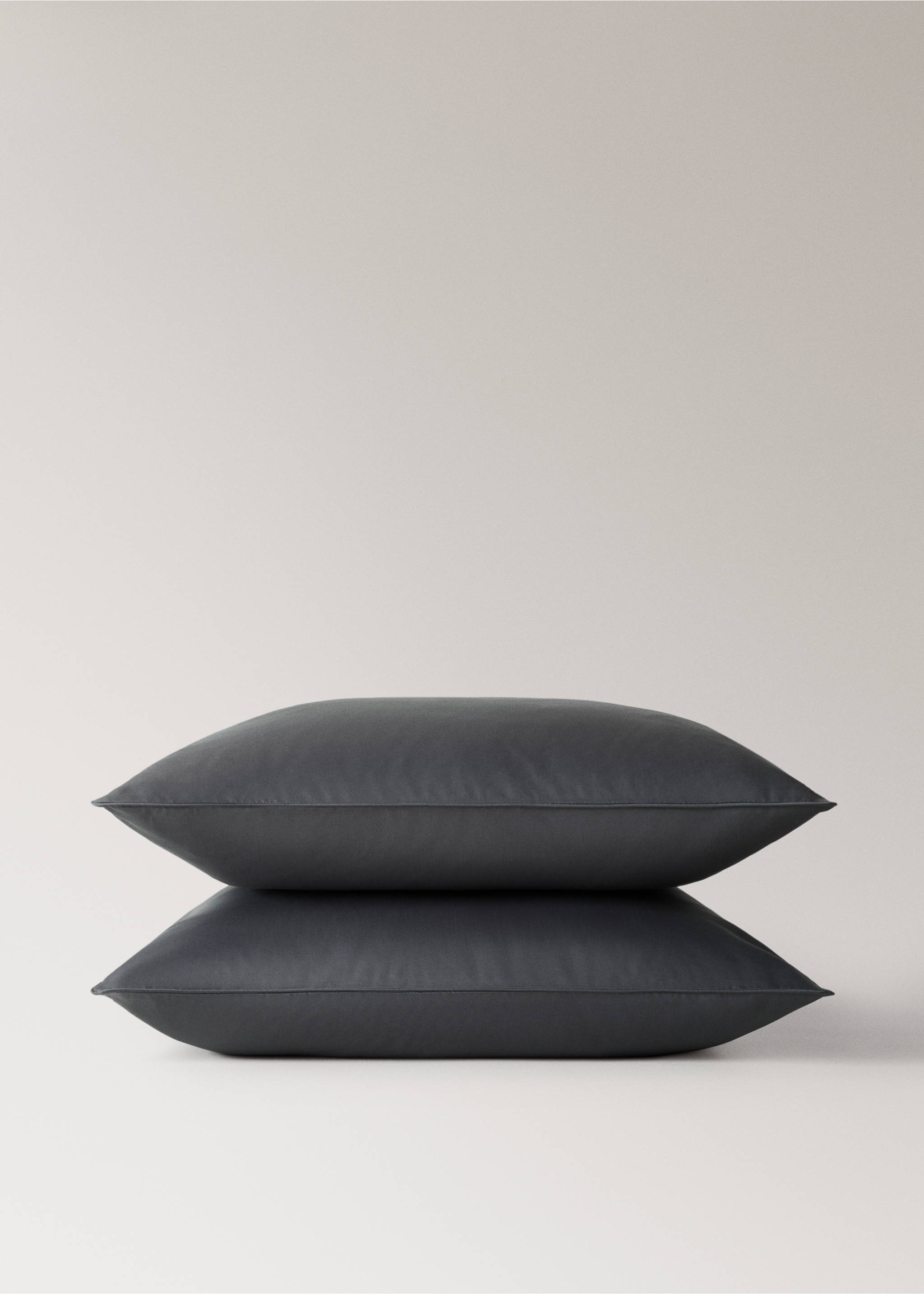 Dark grey pillowcase shown in a stack., Dark Grey. Ref: 17011584-00.