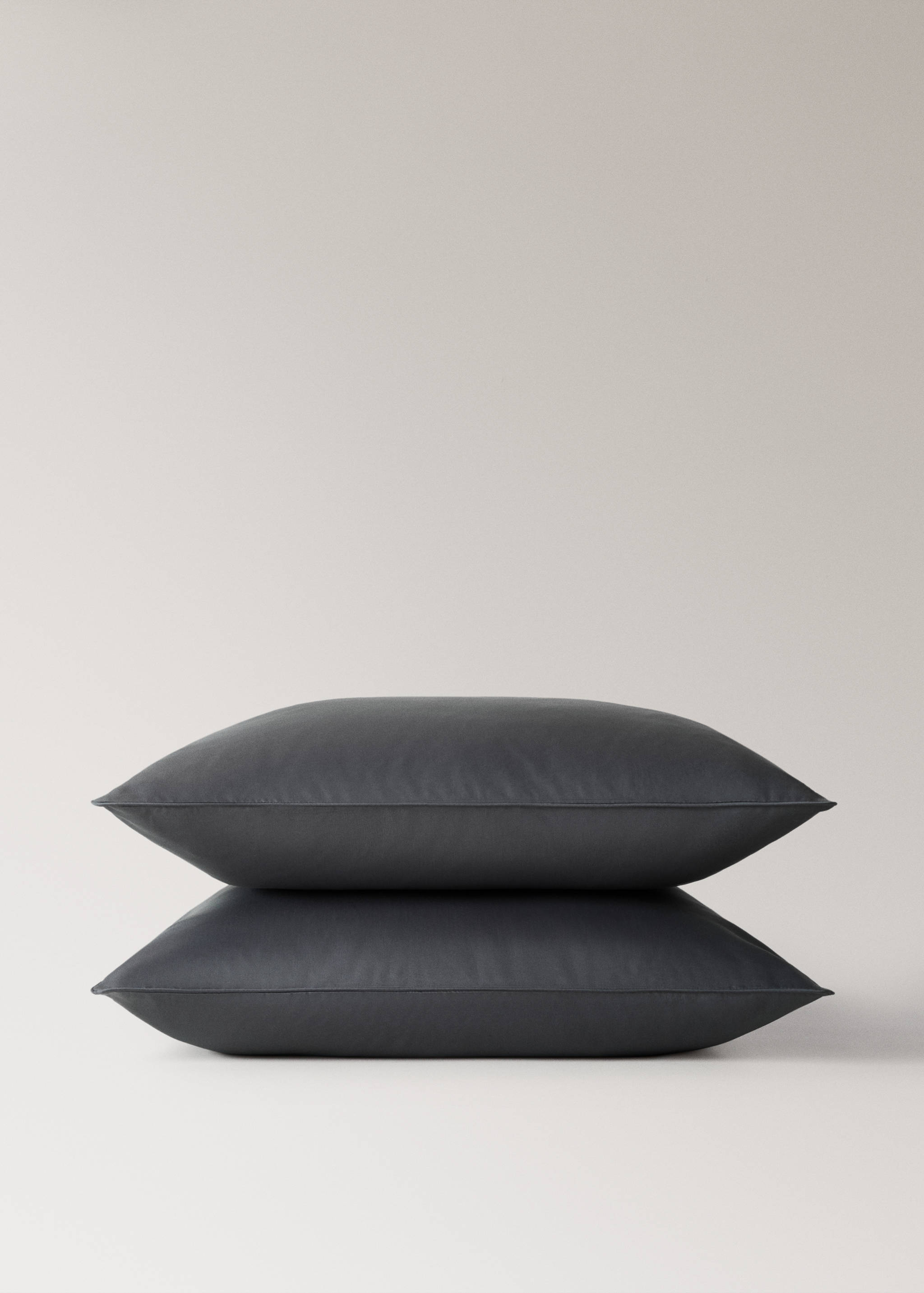 Dark grey pillowcase shown in a stack.