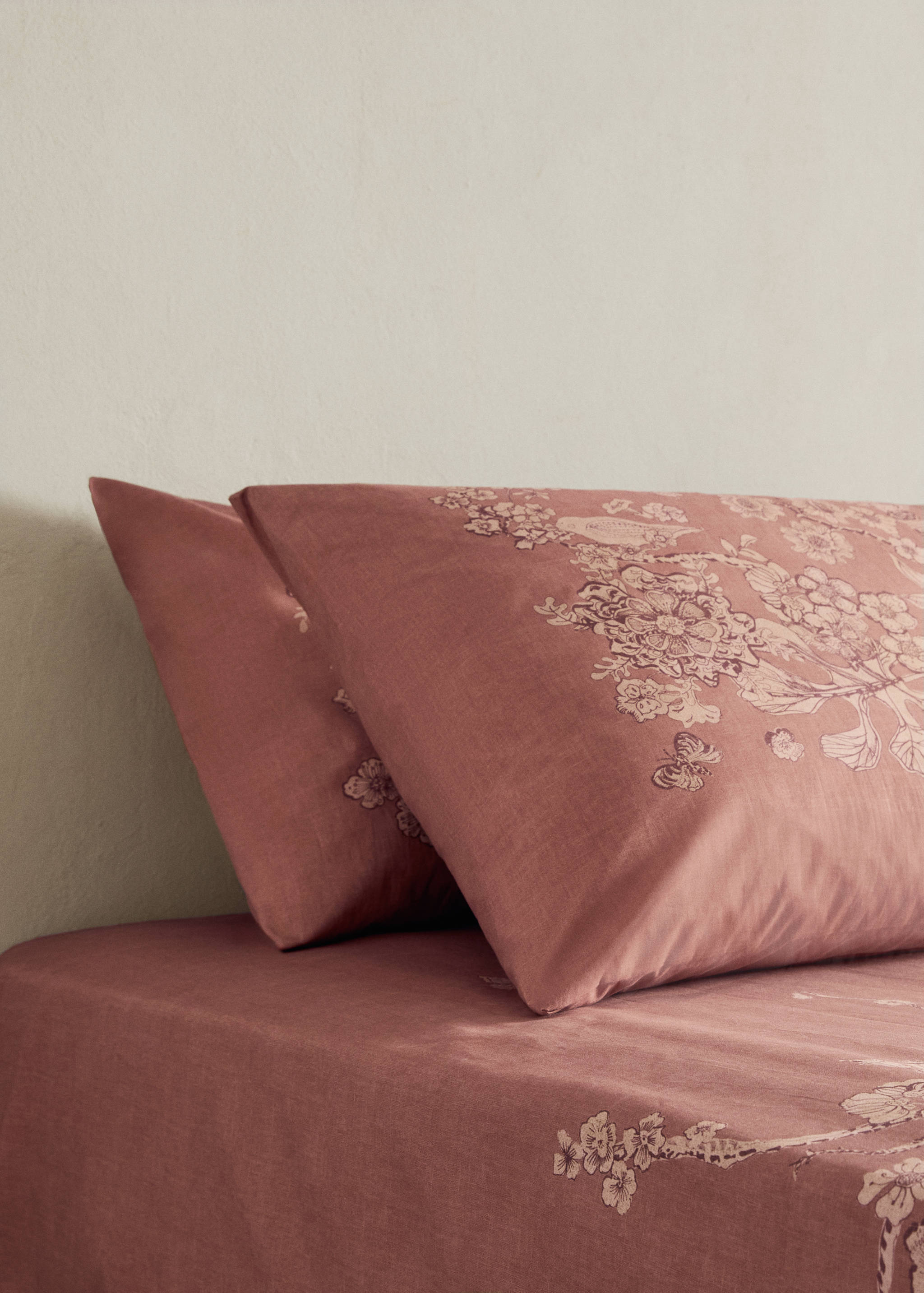 Mauve pillowcase with floral print.