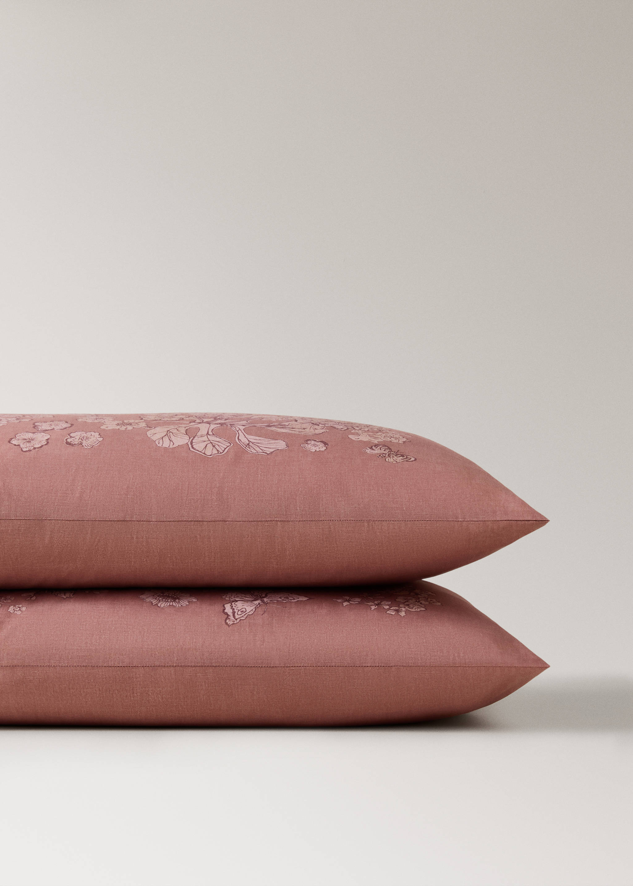 Pink embroidered floral pillowcase in a close-up product view.