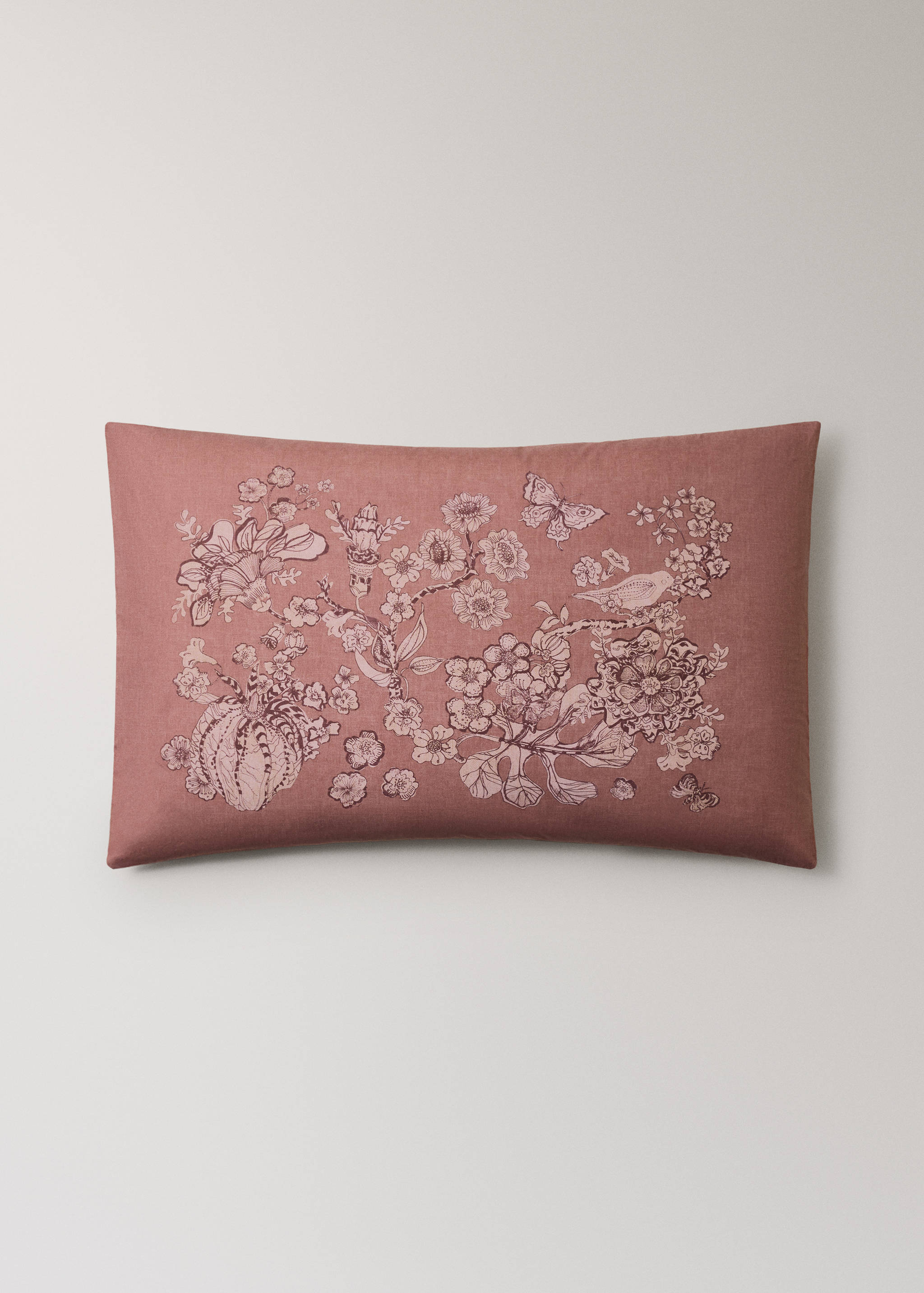 Dusty pink pillowcase with intricate tonal floral and bird embroidery.