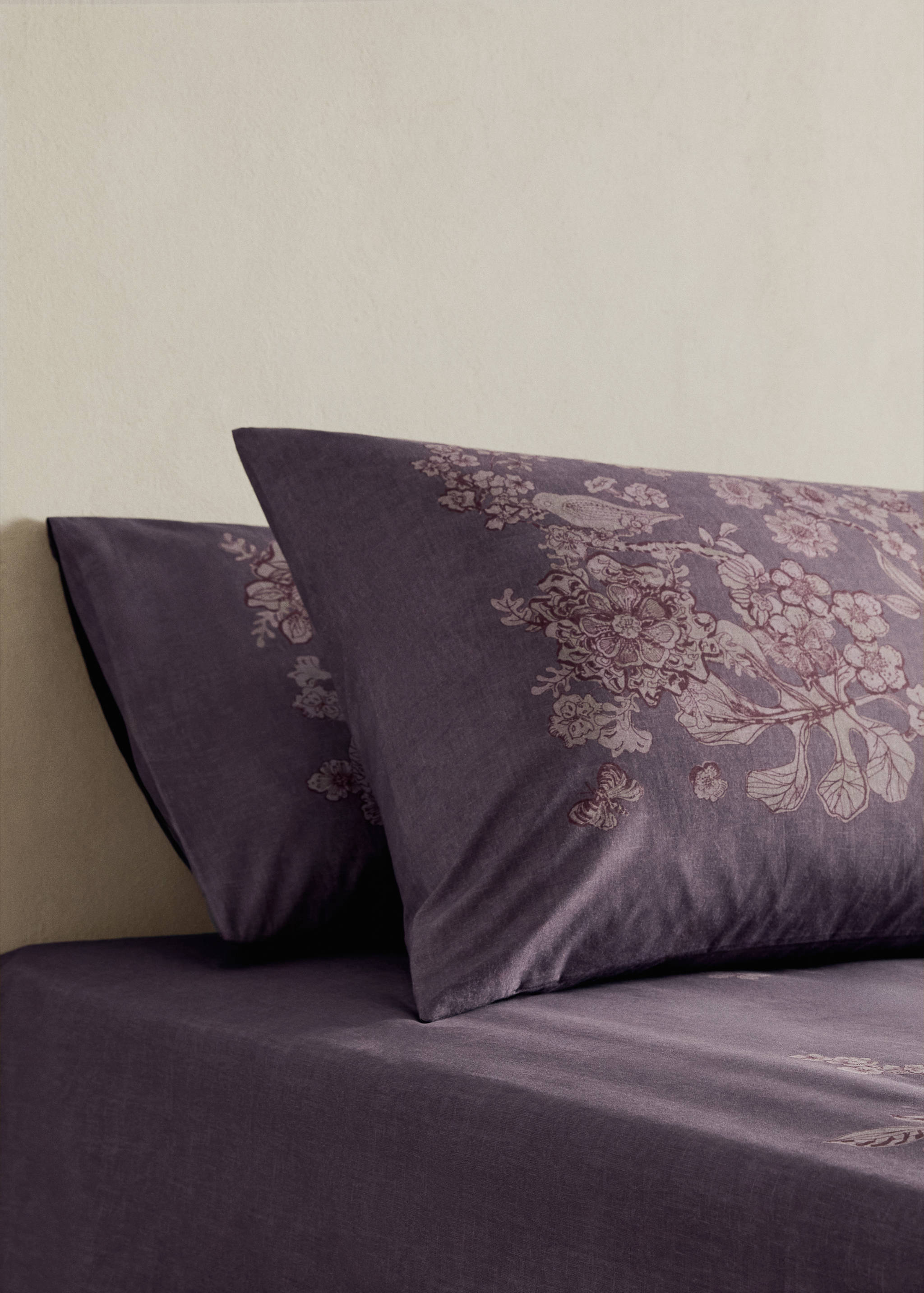 Purple floral print pillowcase with matching bedsheet.