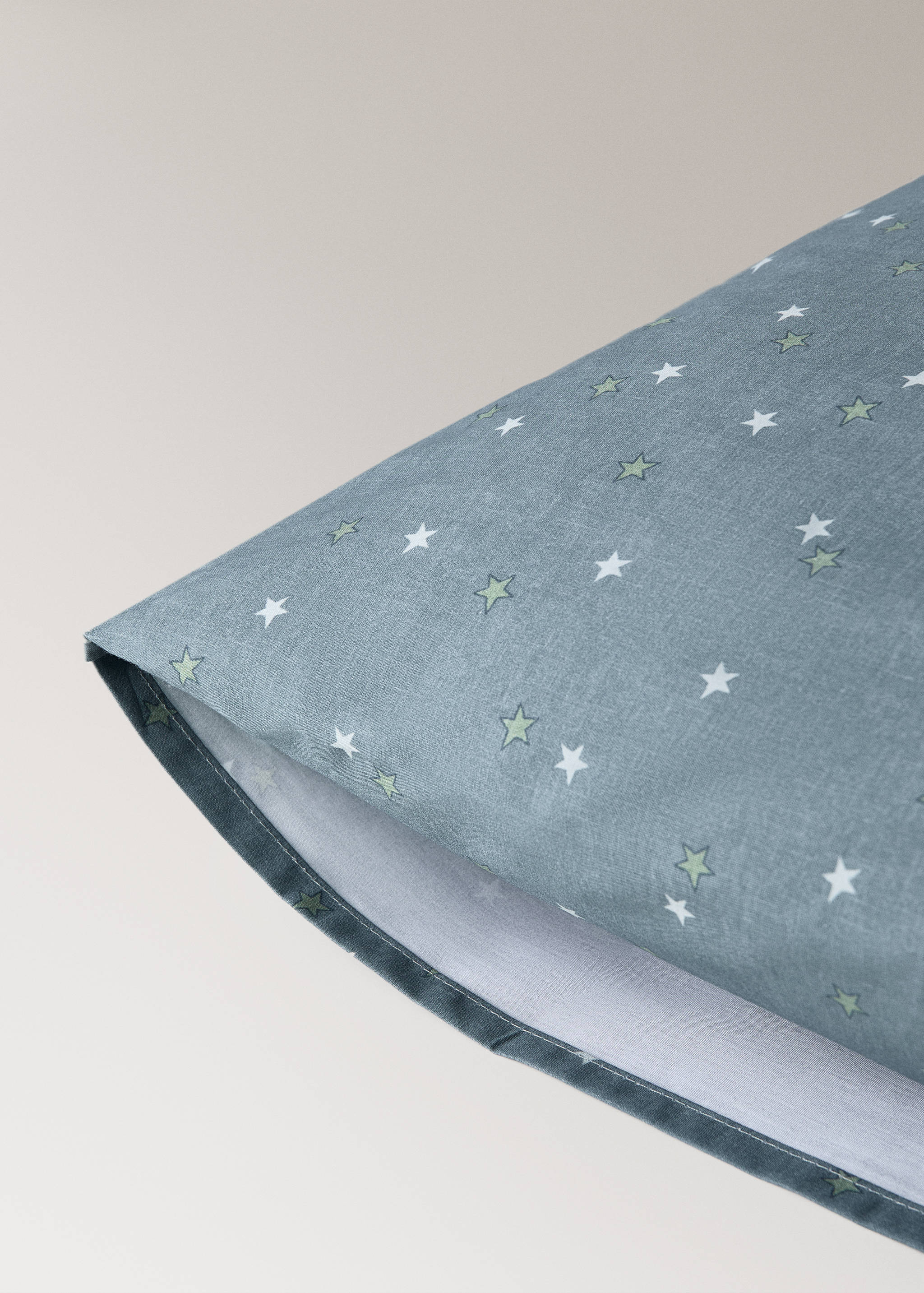Blue-grey star print pillowcase detail.