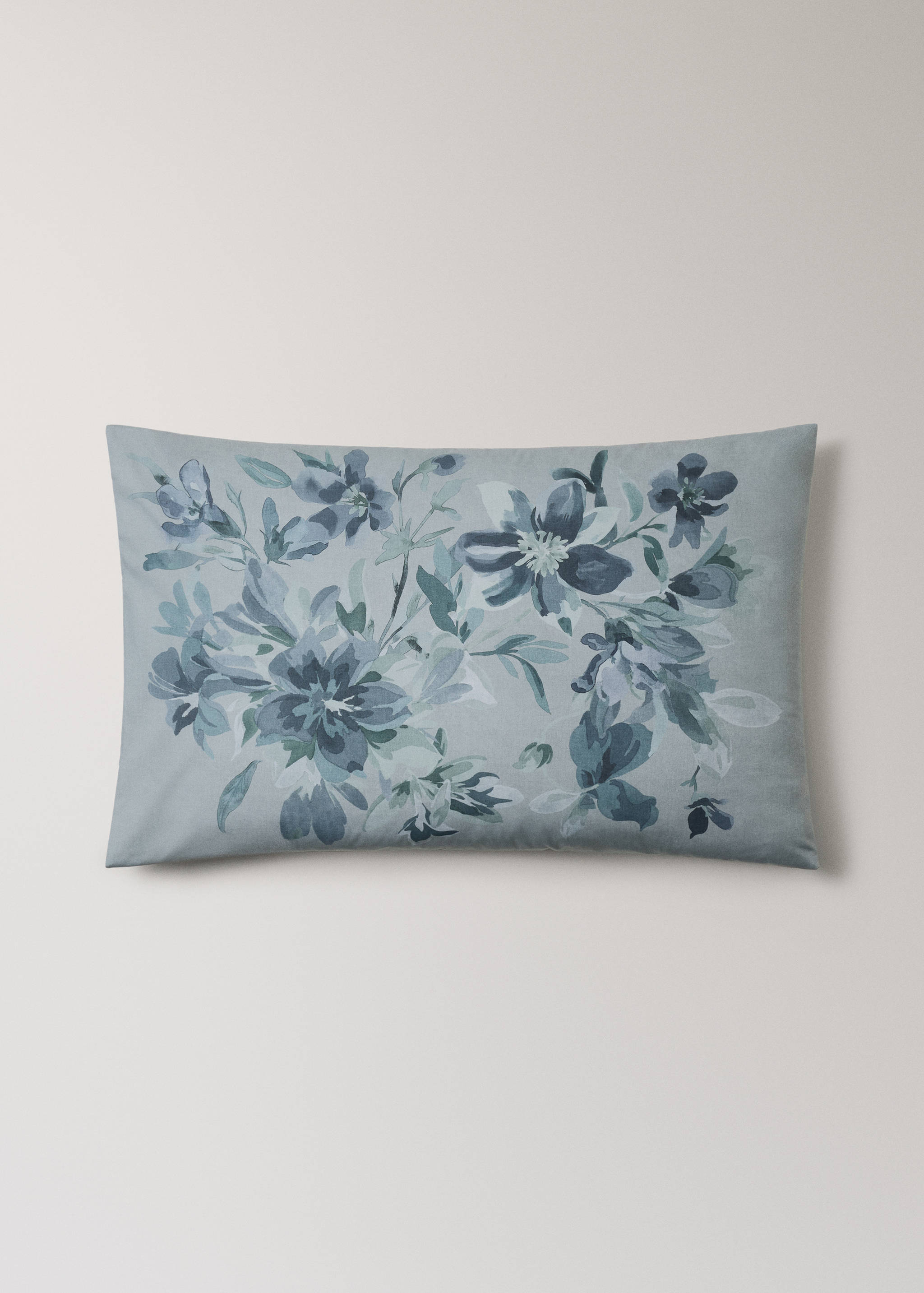Light blue pillowcase with a watercolor floral pattern.