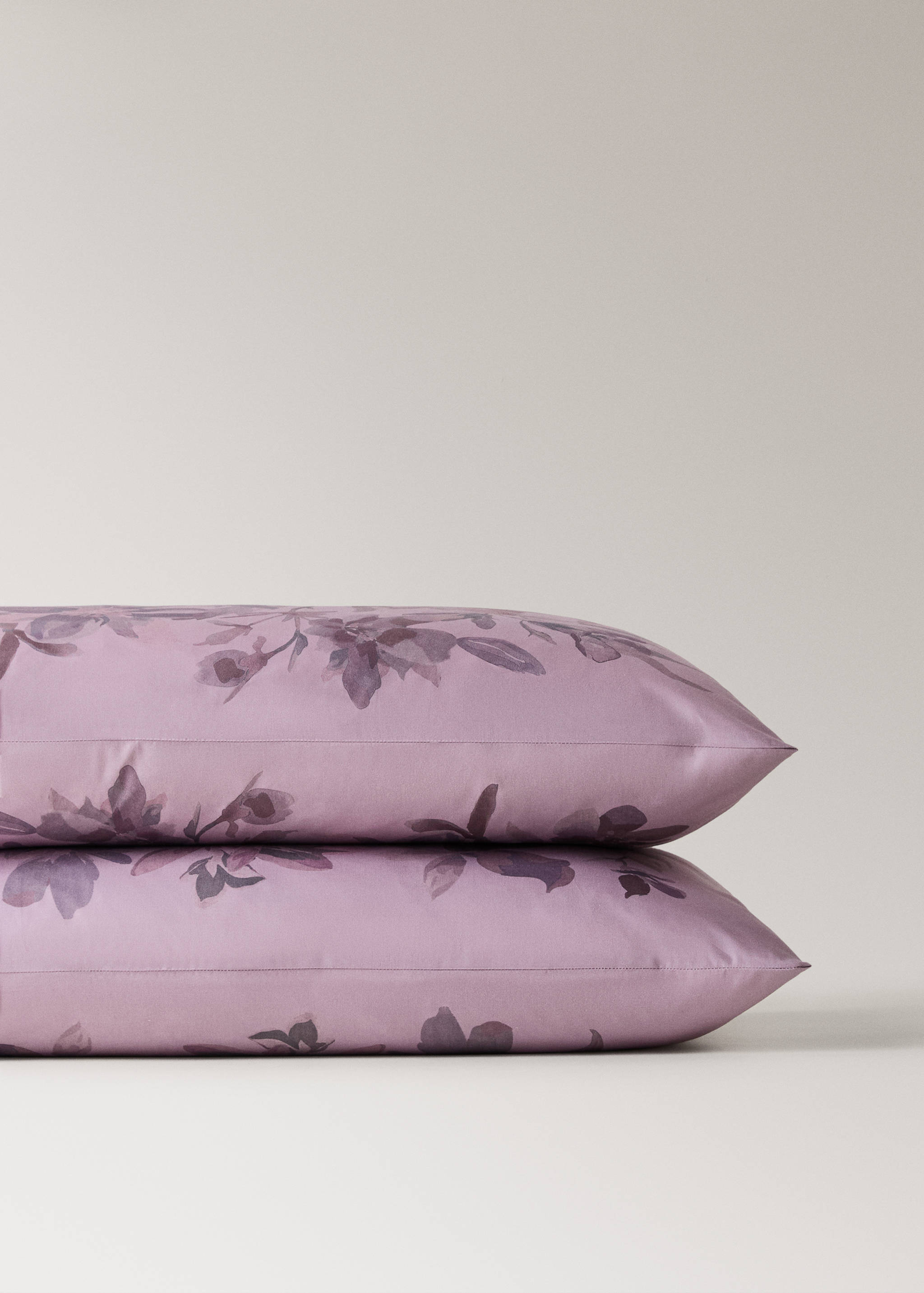 Light purple pillowcase detail with dark purple watercolour floral print.