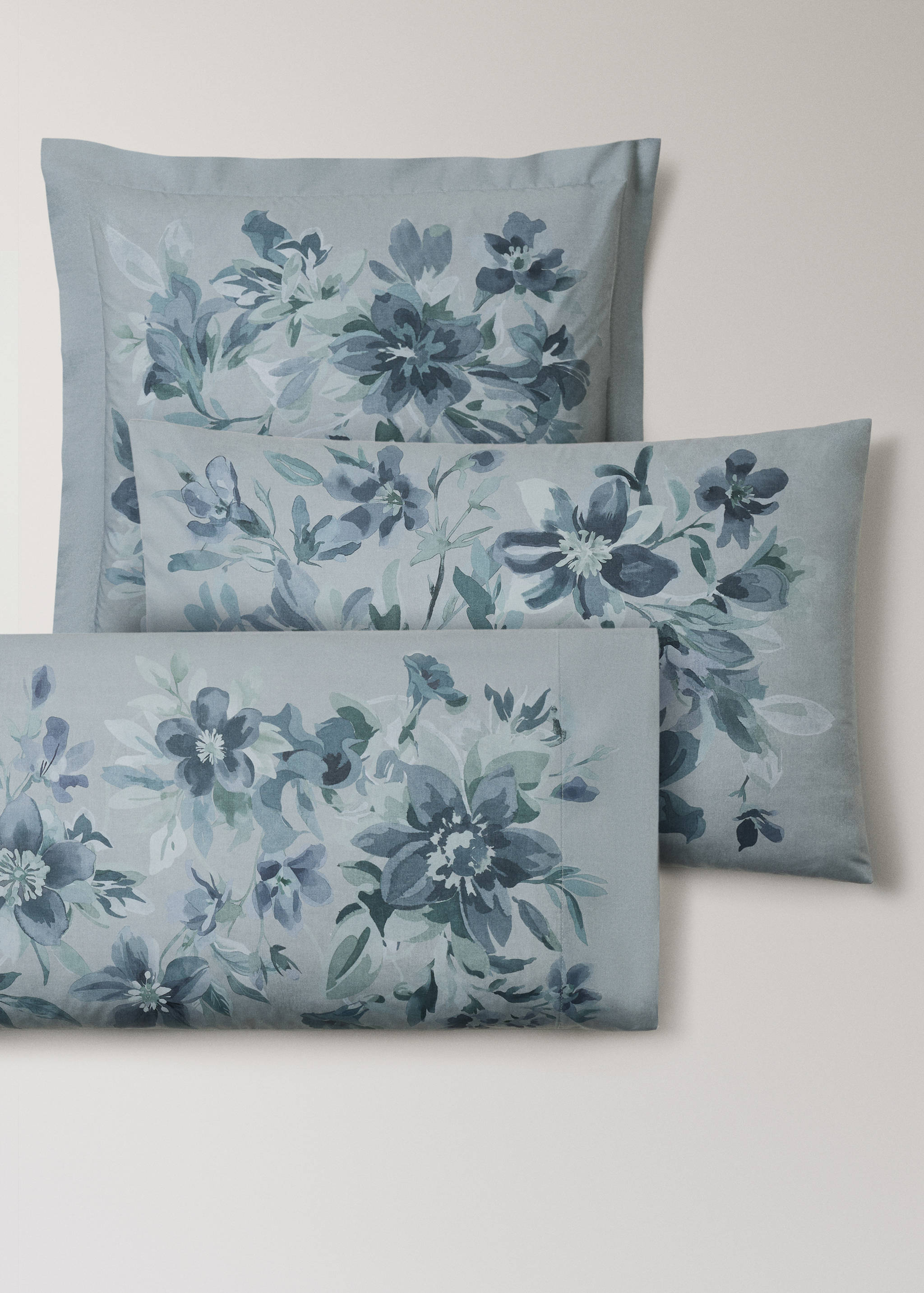 Grey-blue pillowcase with a watercolour floral print.