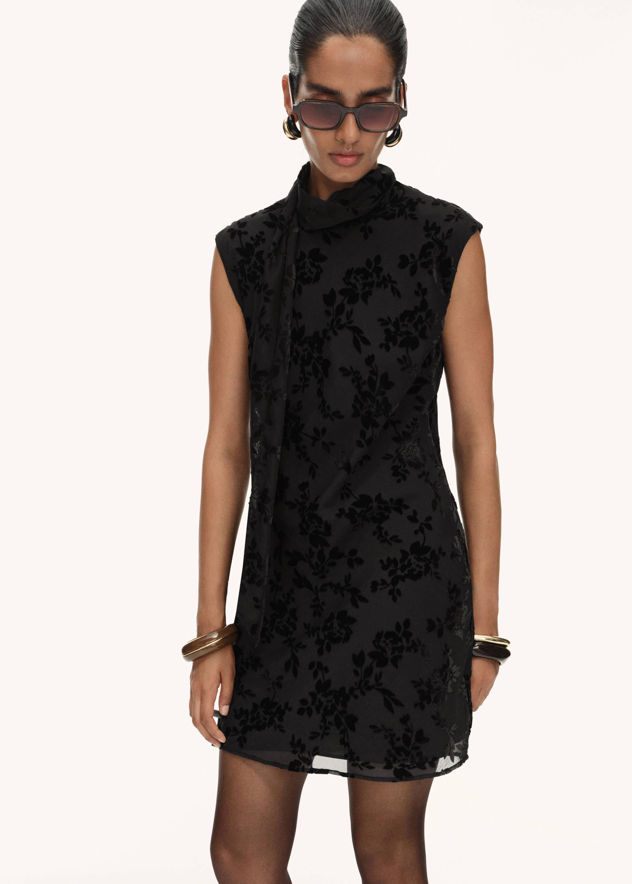 Black velvet burnout floral dress with a high neck and tie detail.