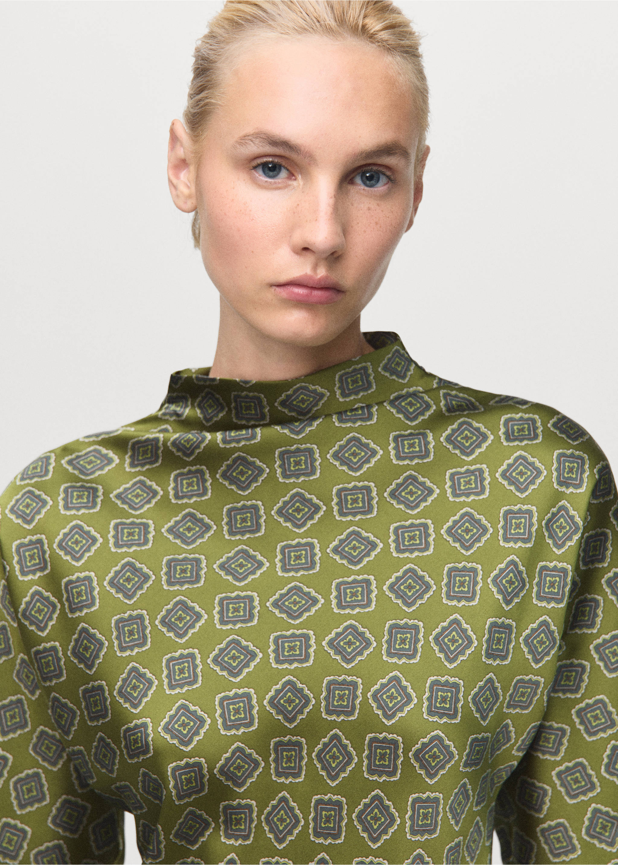 Green patterned dress with a high neckline, worn by a model in a close-up portrait., Green. Ref: 17015832-00.