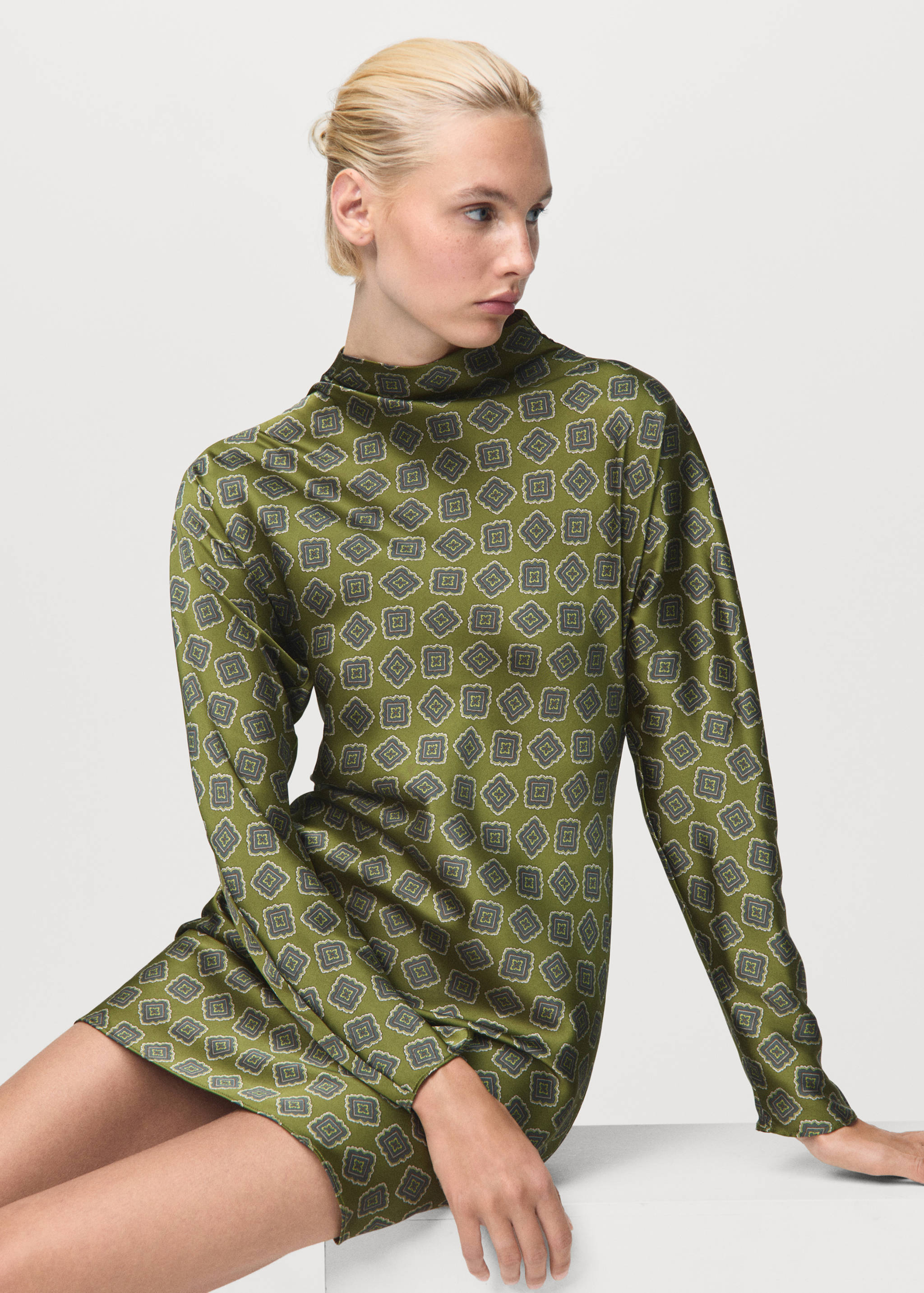 Green geometric print mini dress with long sleeves and high neck.