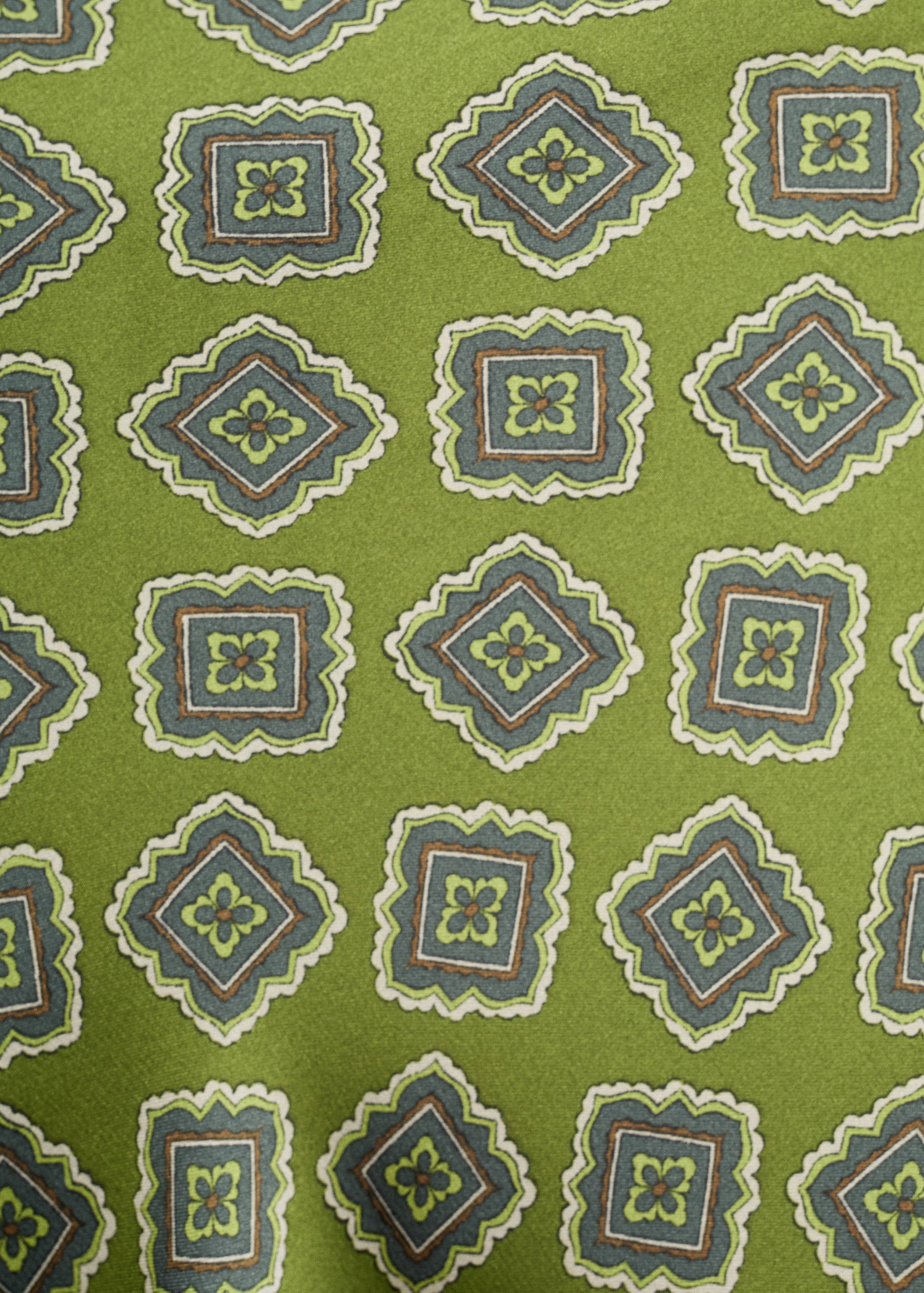Green dress fabric with a geometric print.