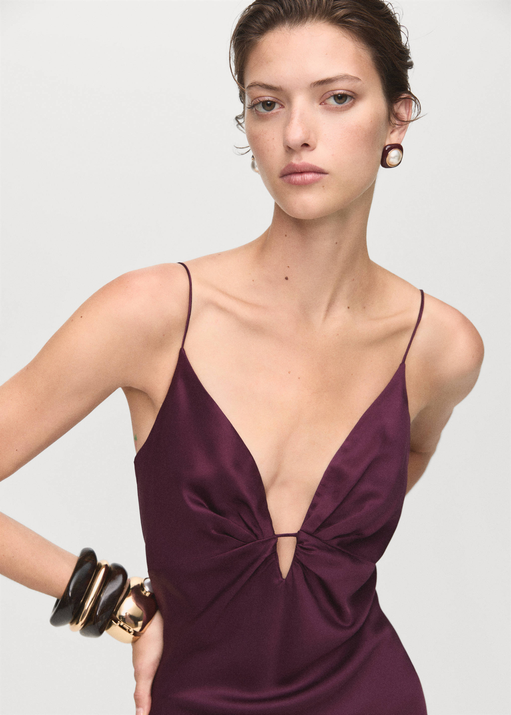 Plum purple satin dress with thin spaghetti straps and deep V-neck.