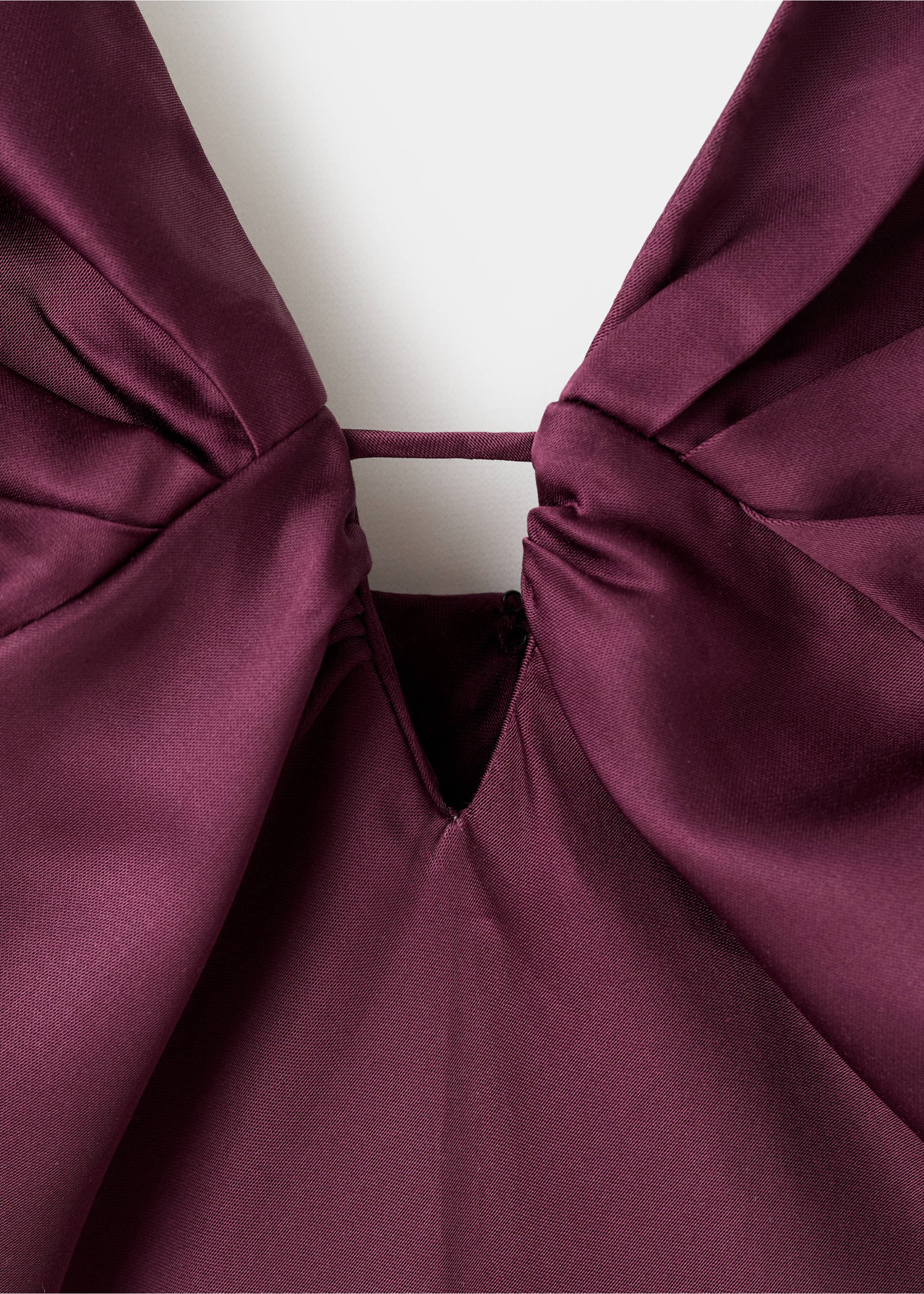 Burgundy dress bodice close-up, showing a pleated deep V-neckline with a fabric bridge detail., Wine. Ref: 17015833-00.