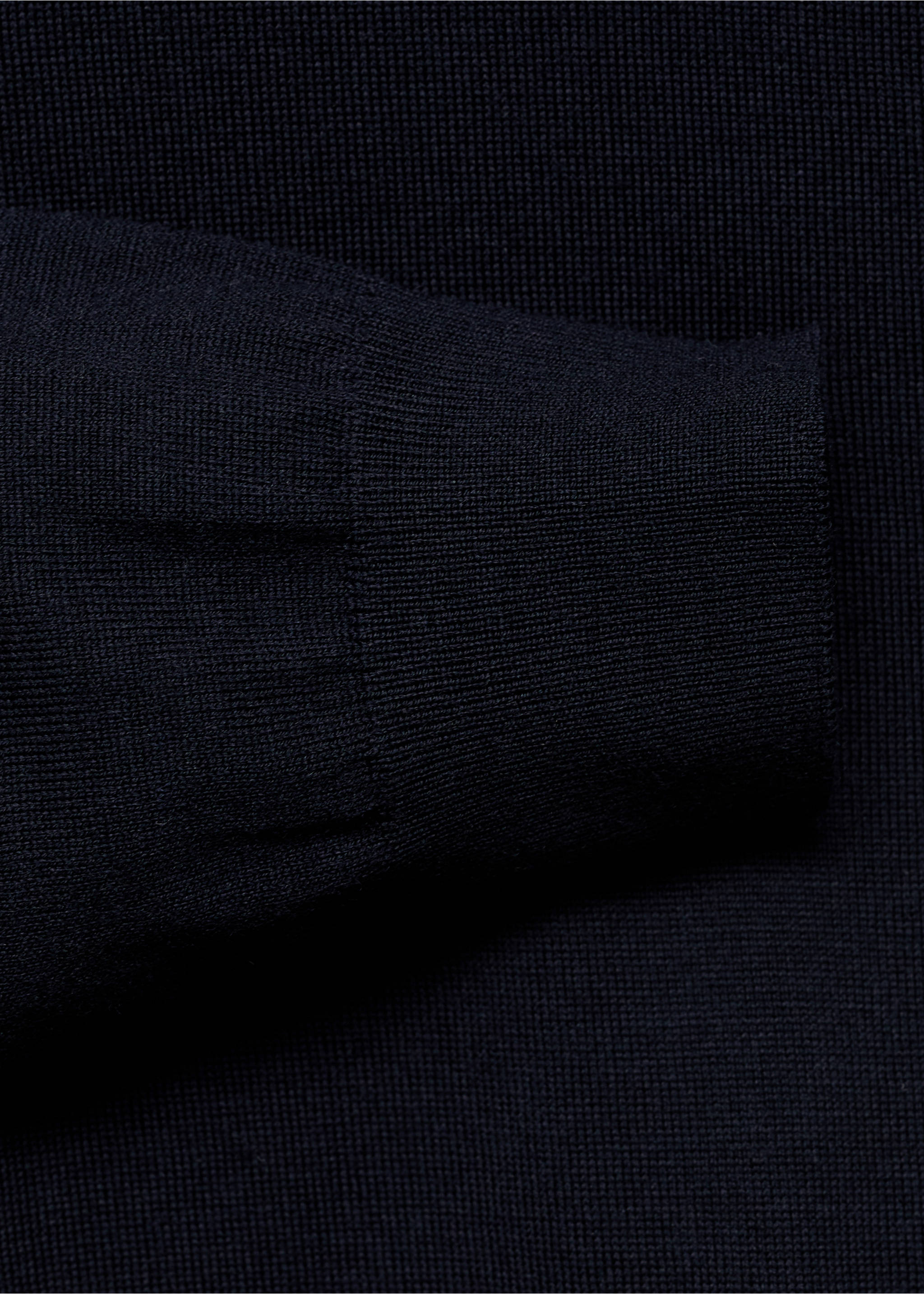 Close-up of the ribbed cuff and knit texture of a navy blue jersey., Navy. Ref: 17015972-00.