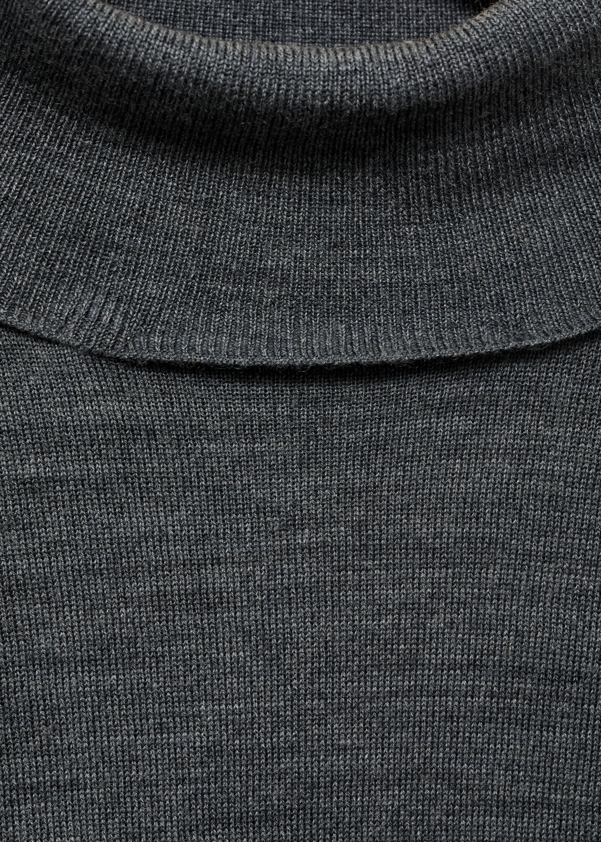Close-up of a dark grey knit roll-neck jersey.