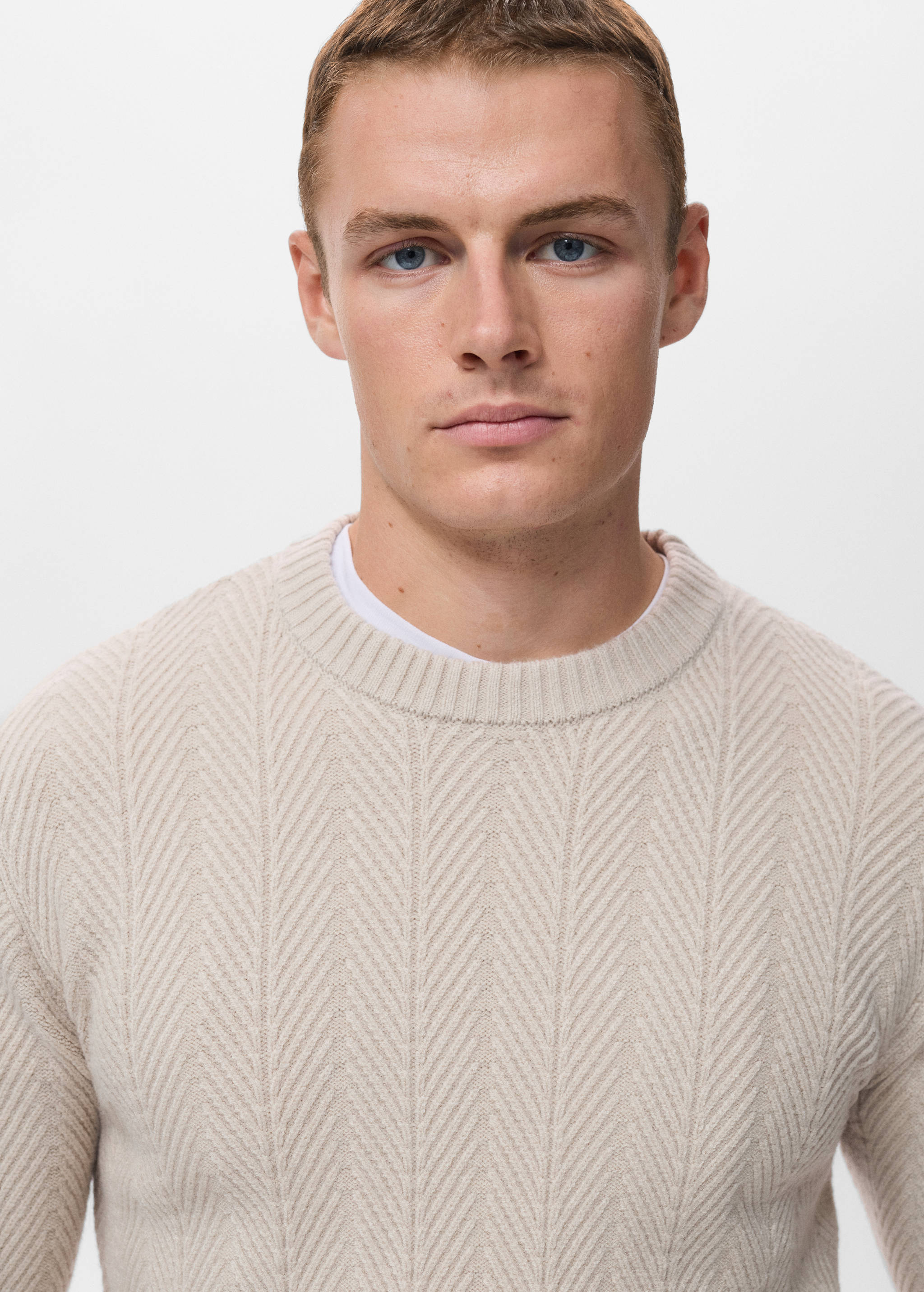 Beige knitted chevron jersey with a ribbed crew neck.