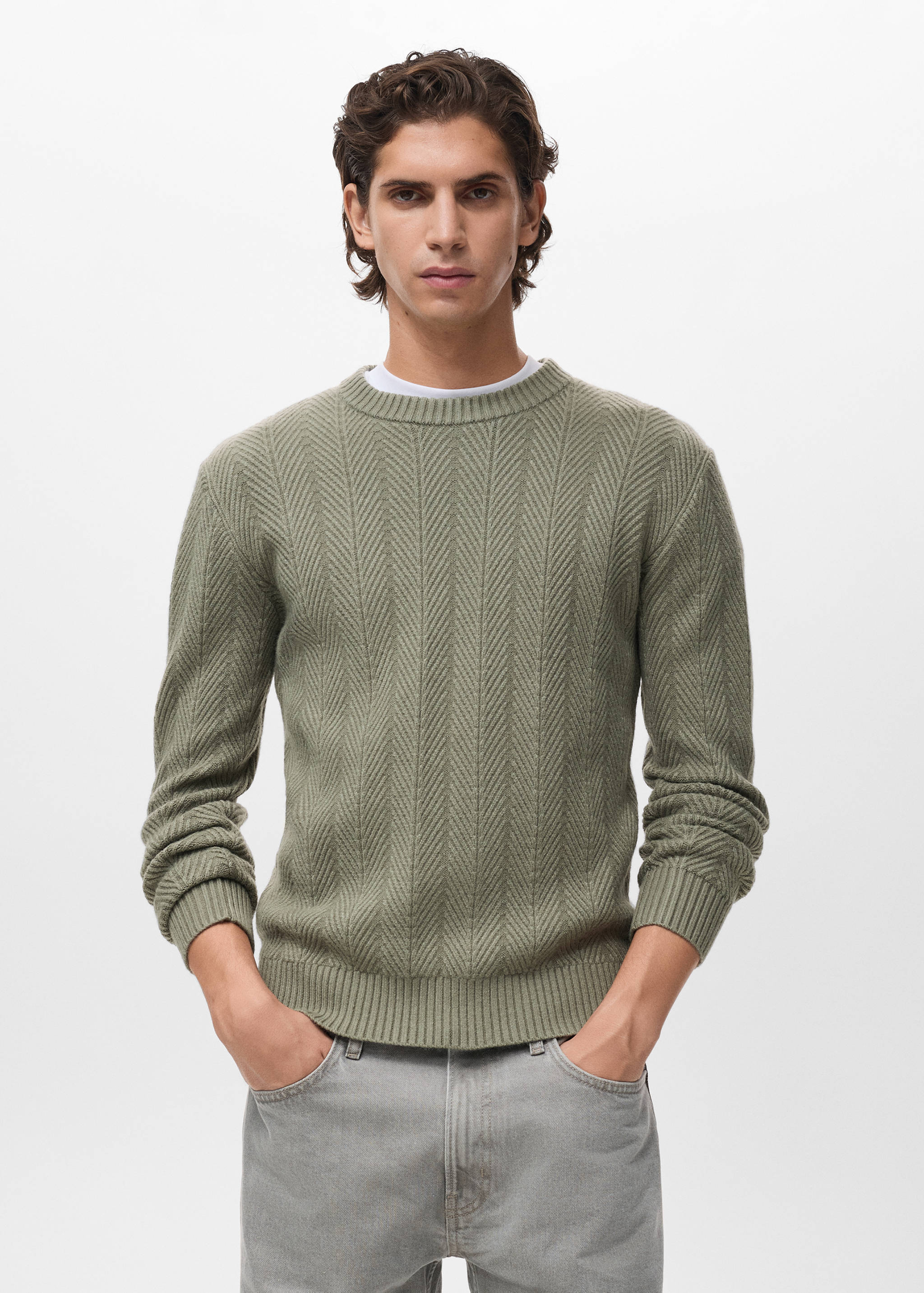 Sage green knitted jersey with a chevron texture and round neckline.