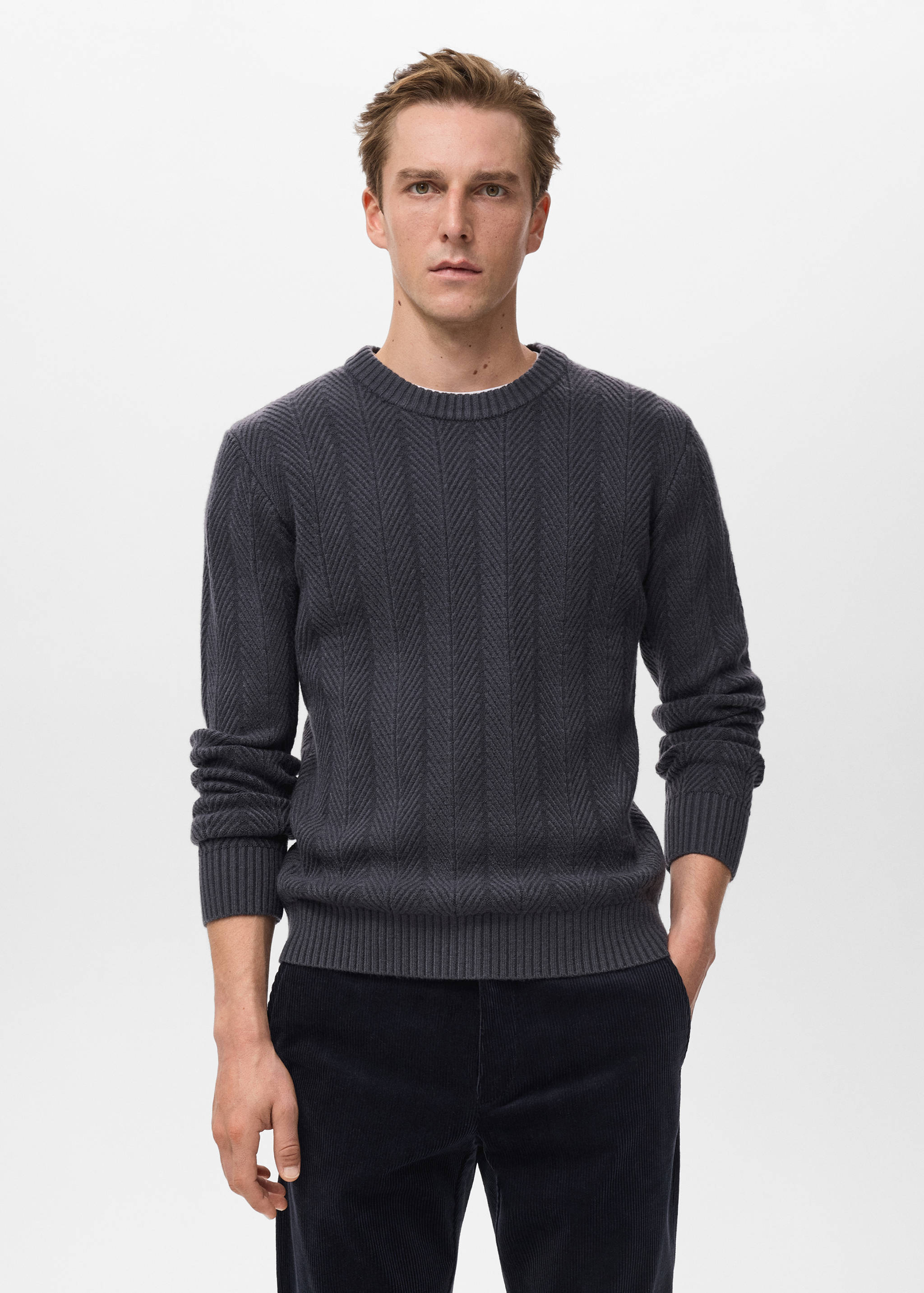 Dark grey knitted jersey with a chevron pattern and crew neck.