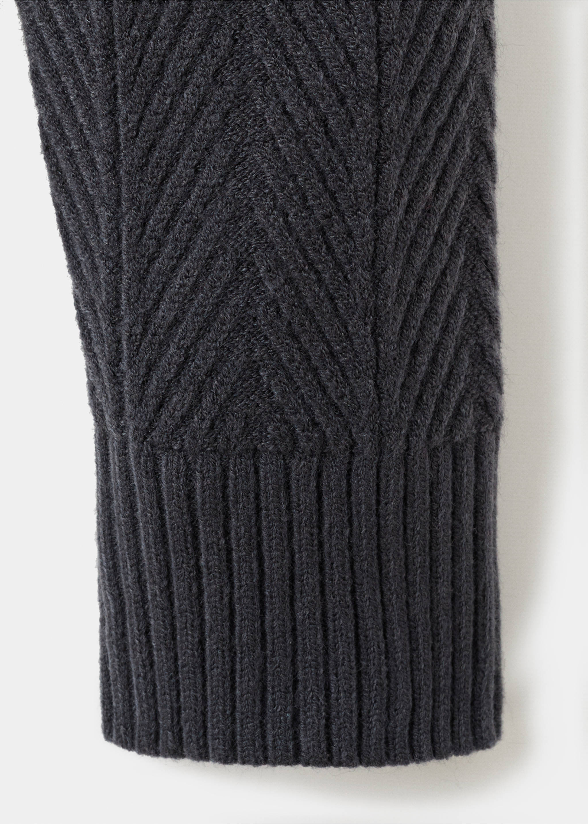 Close-up of a dark grey knit jersey showing the chevron texture and ribbed cuff., Indigo Blue. Ref: 17017904-00.