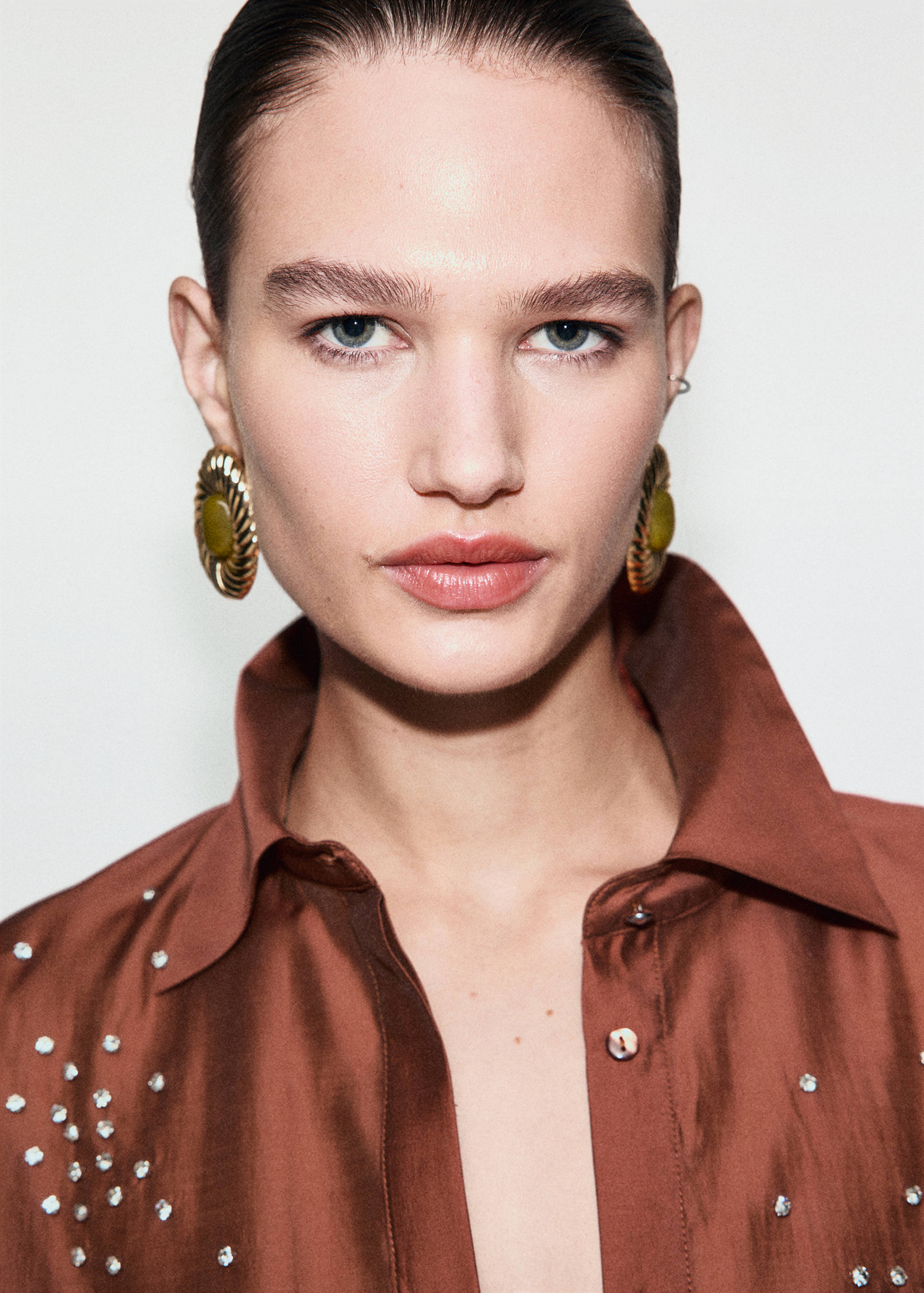 Brown rhinestone-embellished shirt with a pointed collar.