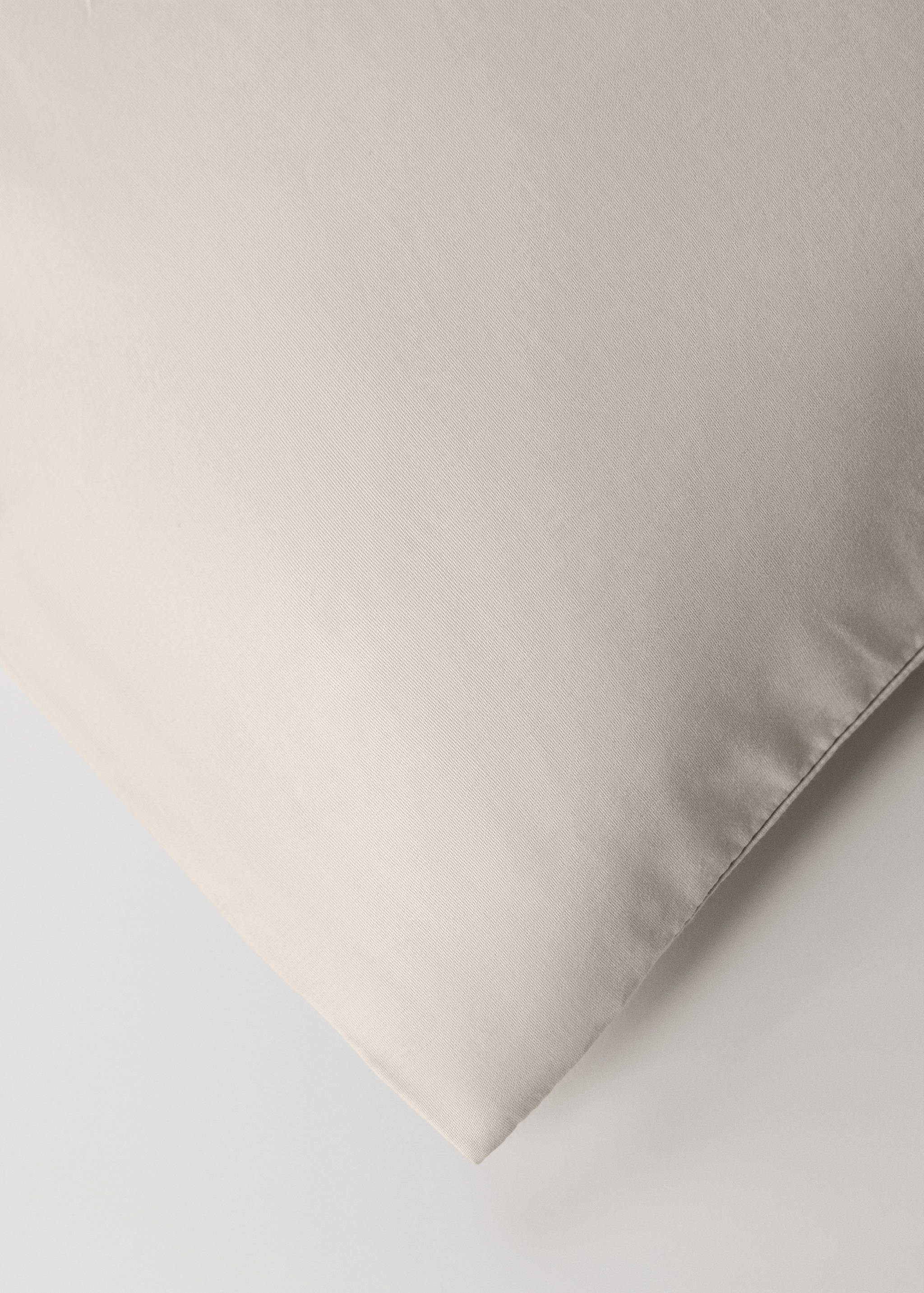 Close-up of a neutral beige duvet cover fabric detail.