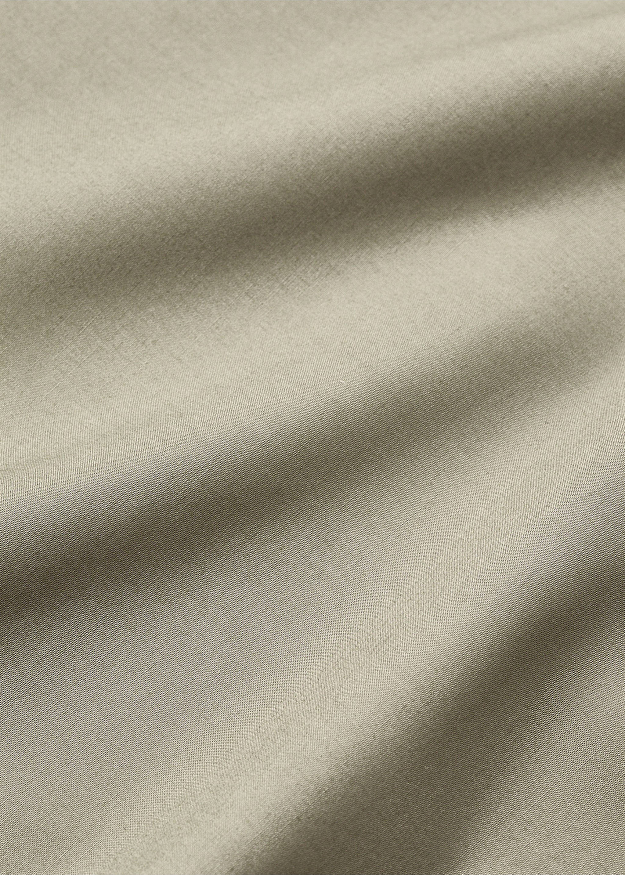 Close-up of a neutral flat sheet showing its soft woven texture., Olive Green. Ref: 17021586-00.