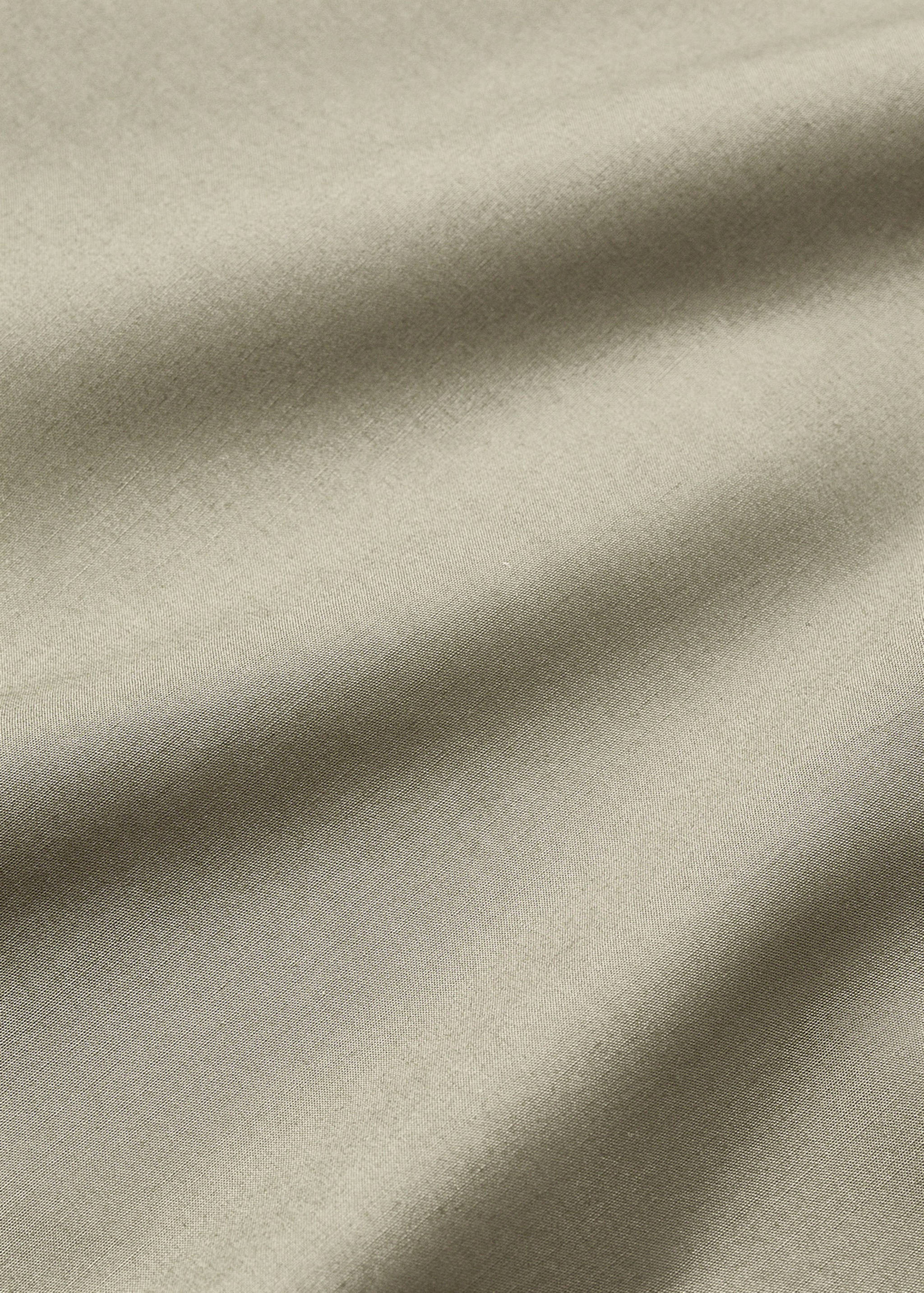 Close-up of a neutral flat sheet showing its soft woven texture.