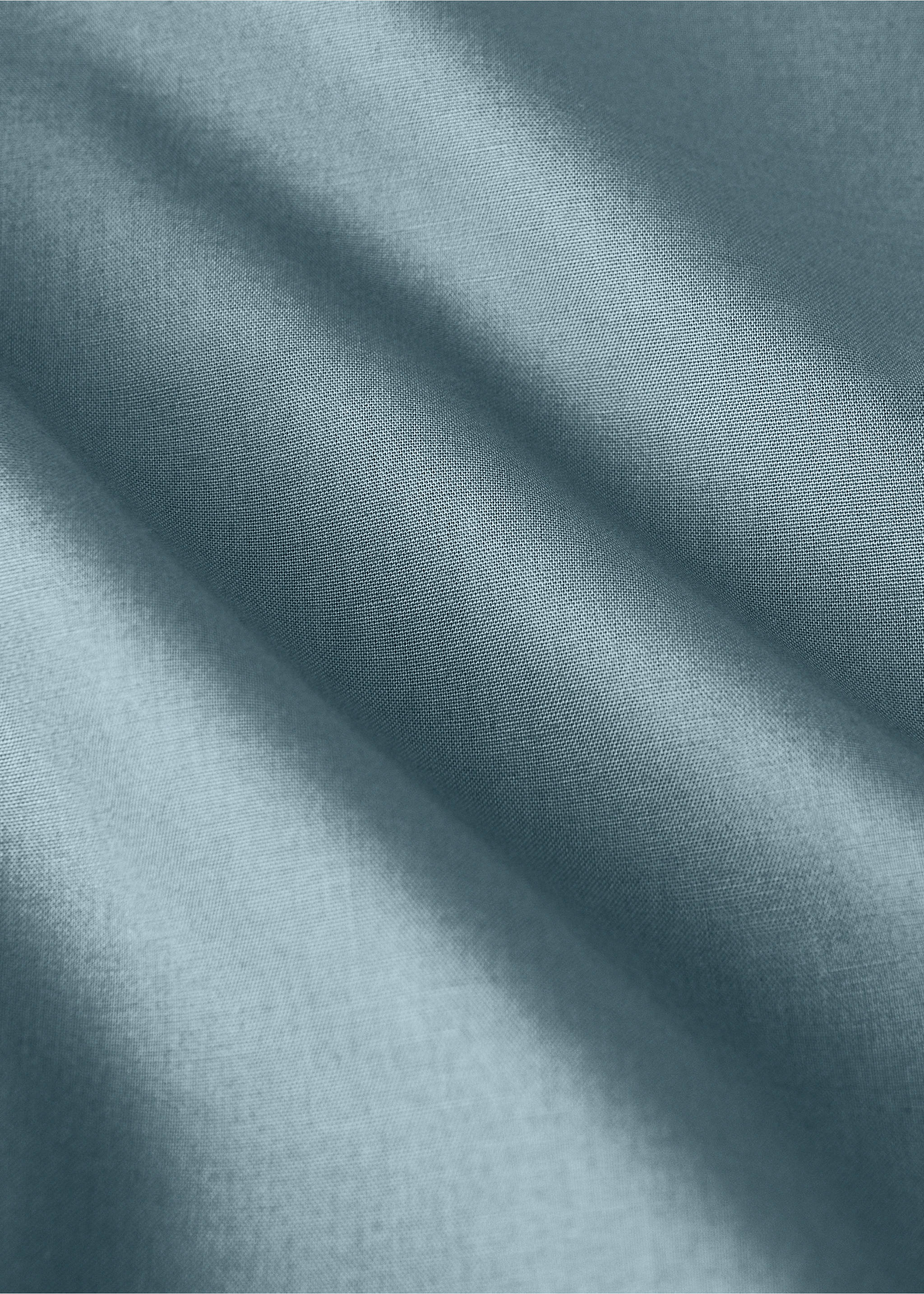Close-up of a muted grey-blue flat sheet showing fabric texture., Blue. Ref: 17021586-00.