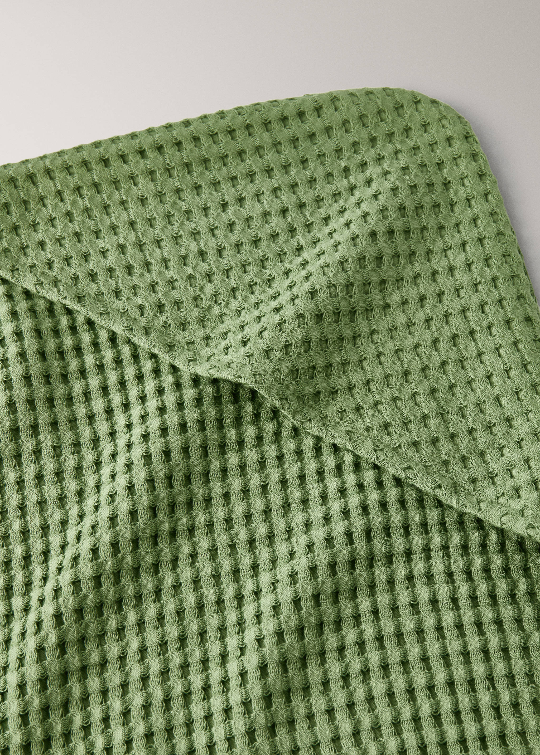 Green waffle-texture towel detail.