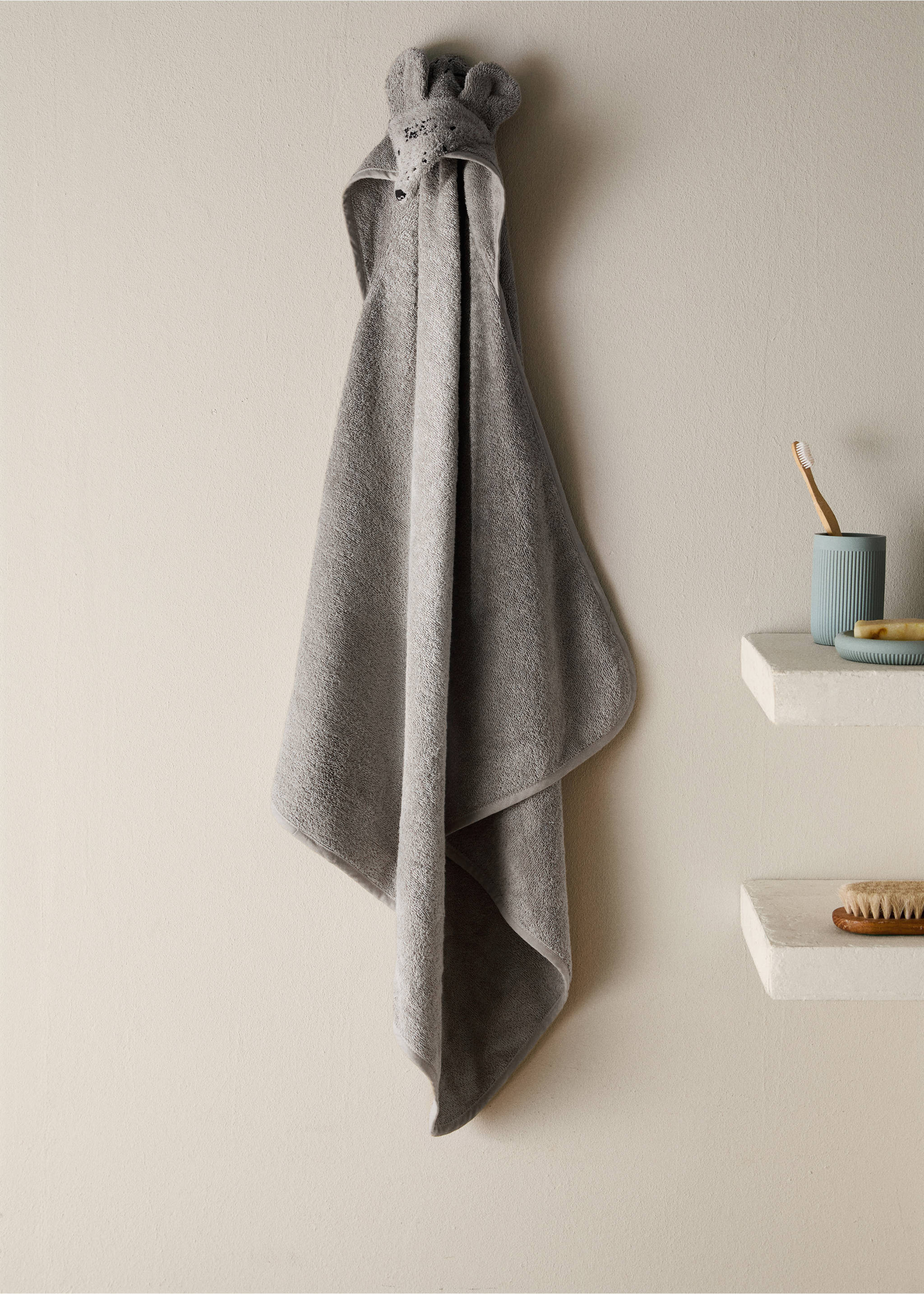 Grey hooded towel with animal ears hanging on a wall., Medium Brown. Ref: 17021638-00.
