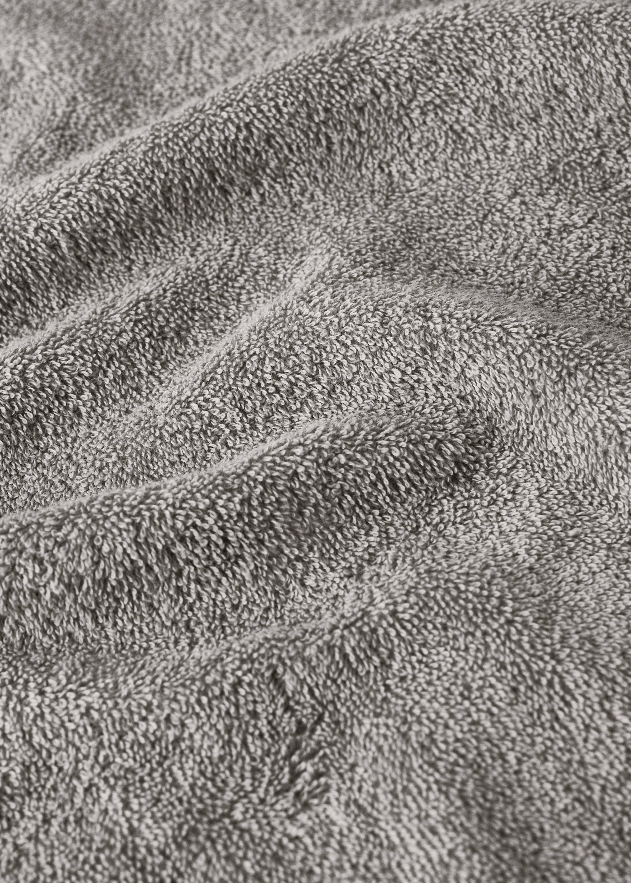 Close-up of a grey towel showing the soft looped texture.