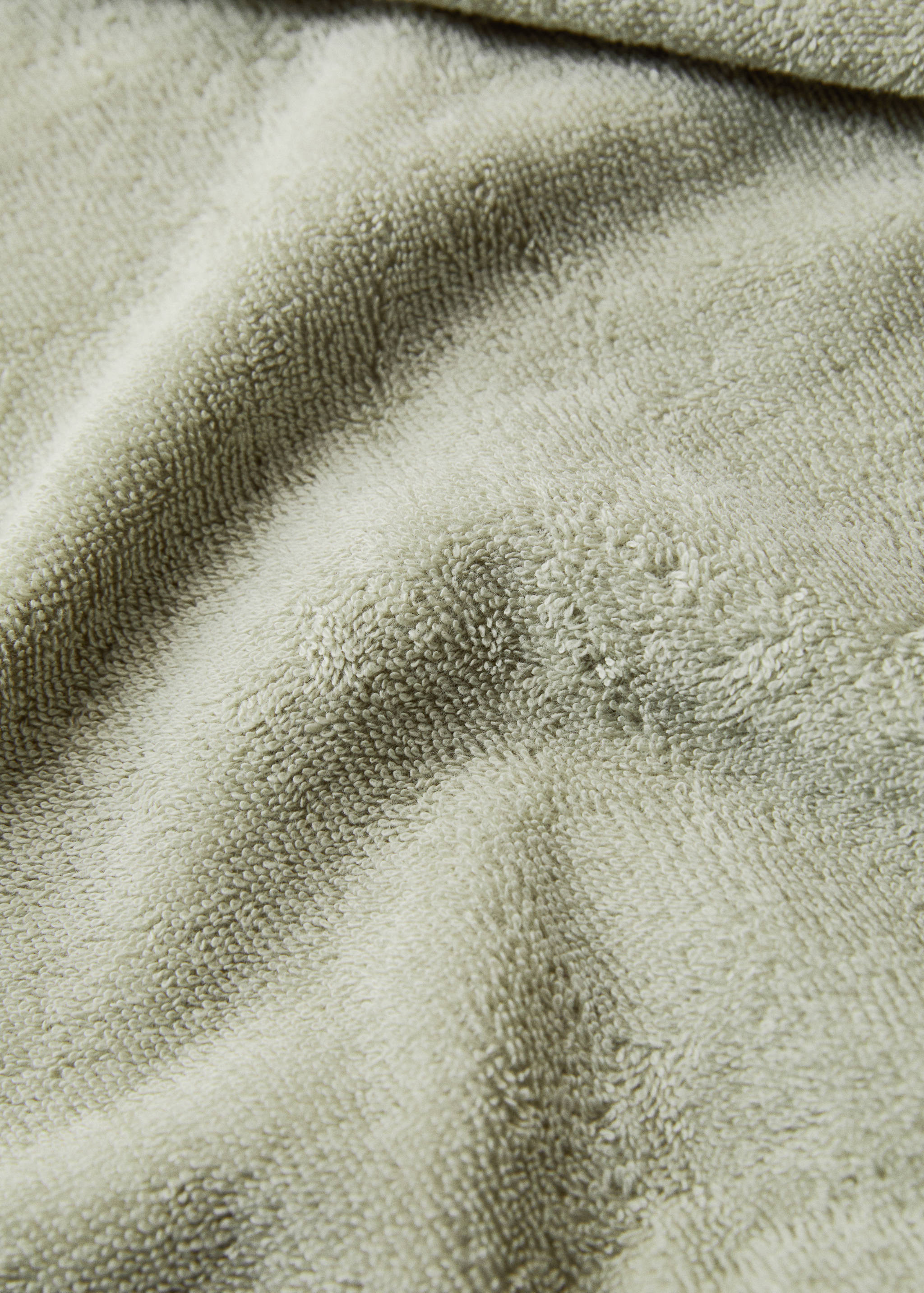 Close-up of a light green textured towel.