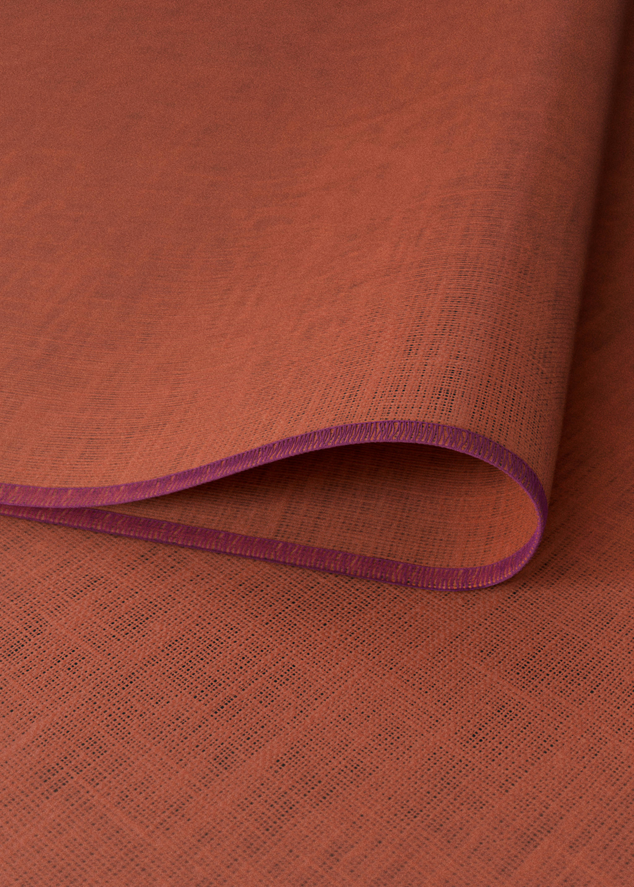 Rust orange woven individual placemat with a contrasting purple hem detail.