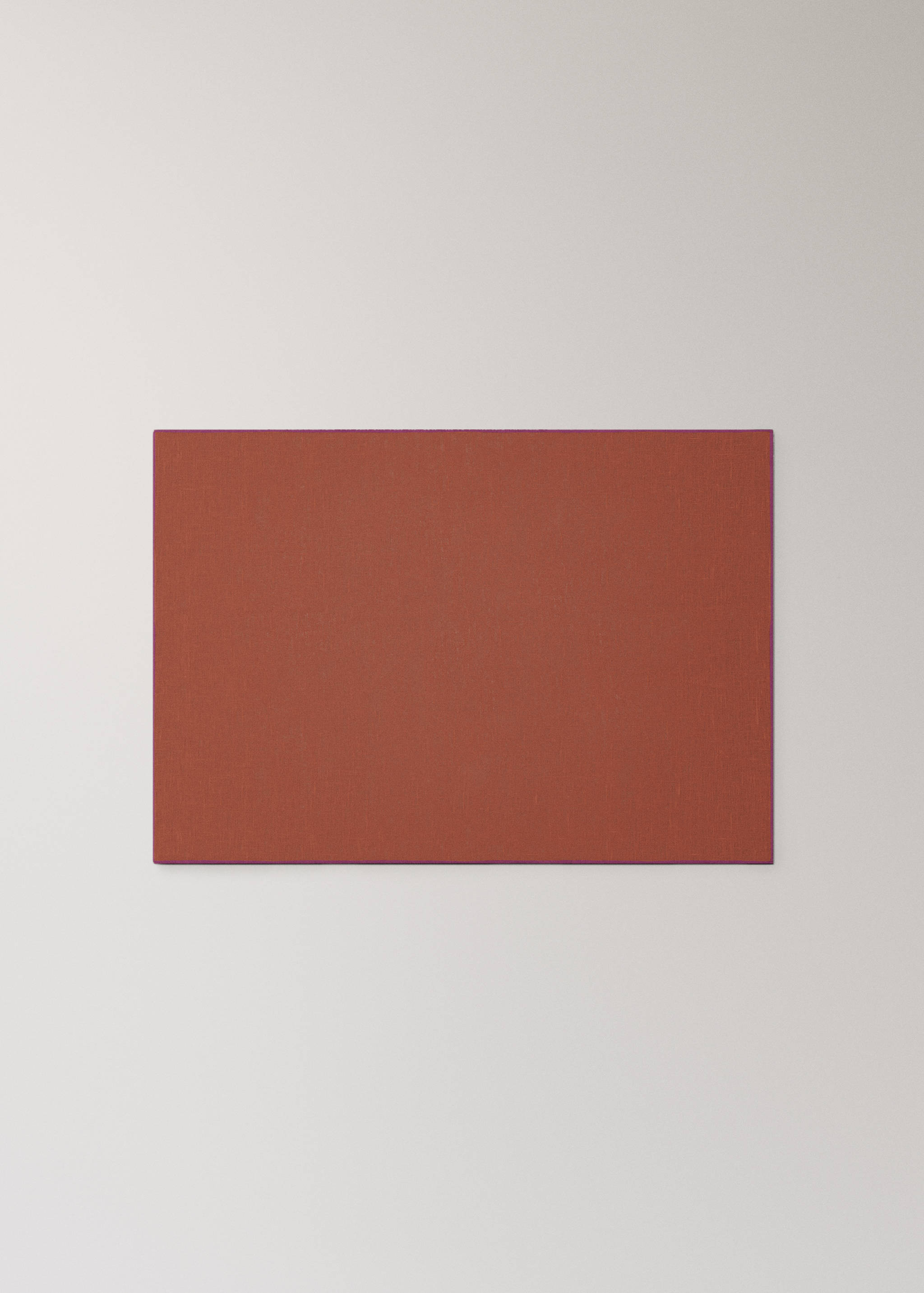 Rectangular terracotta red placemat in a still-life setting.