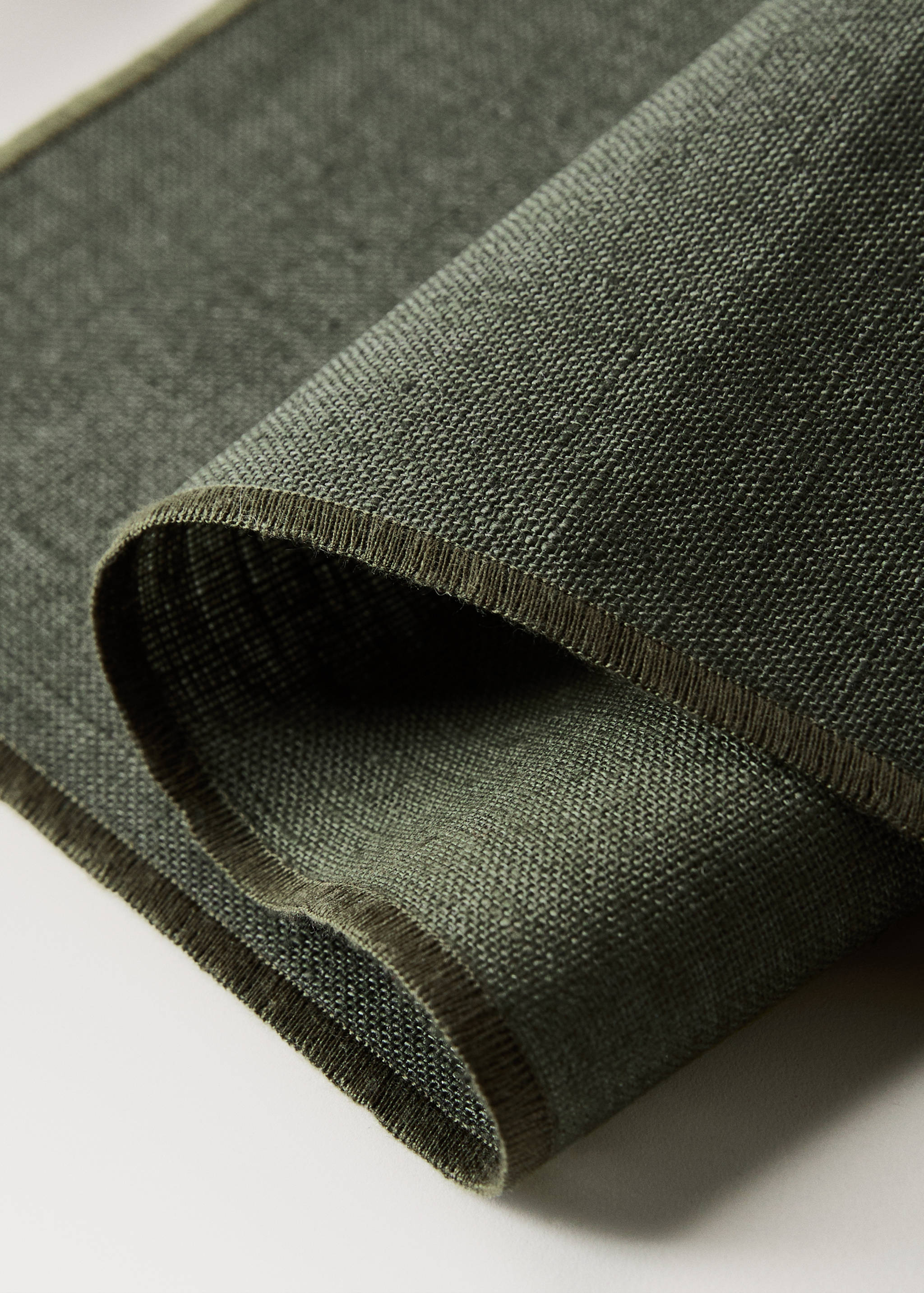 Olive green placemat with a textured weave and bound border.