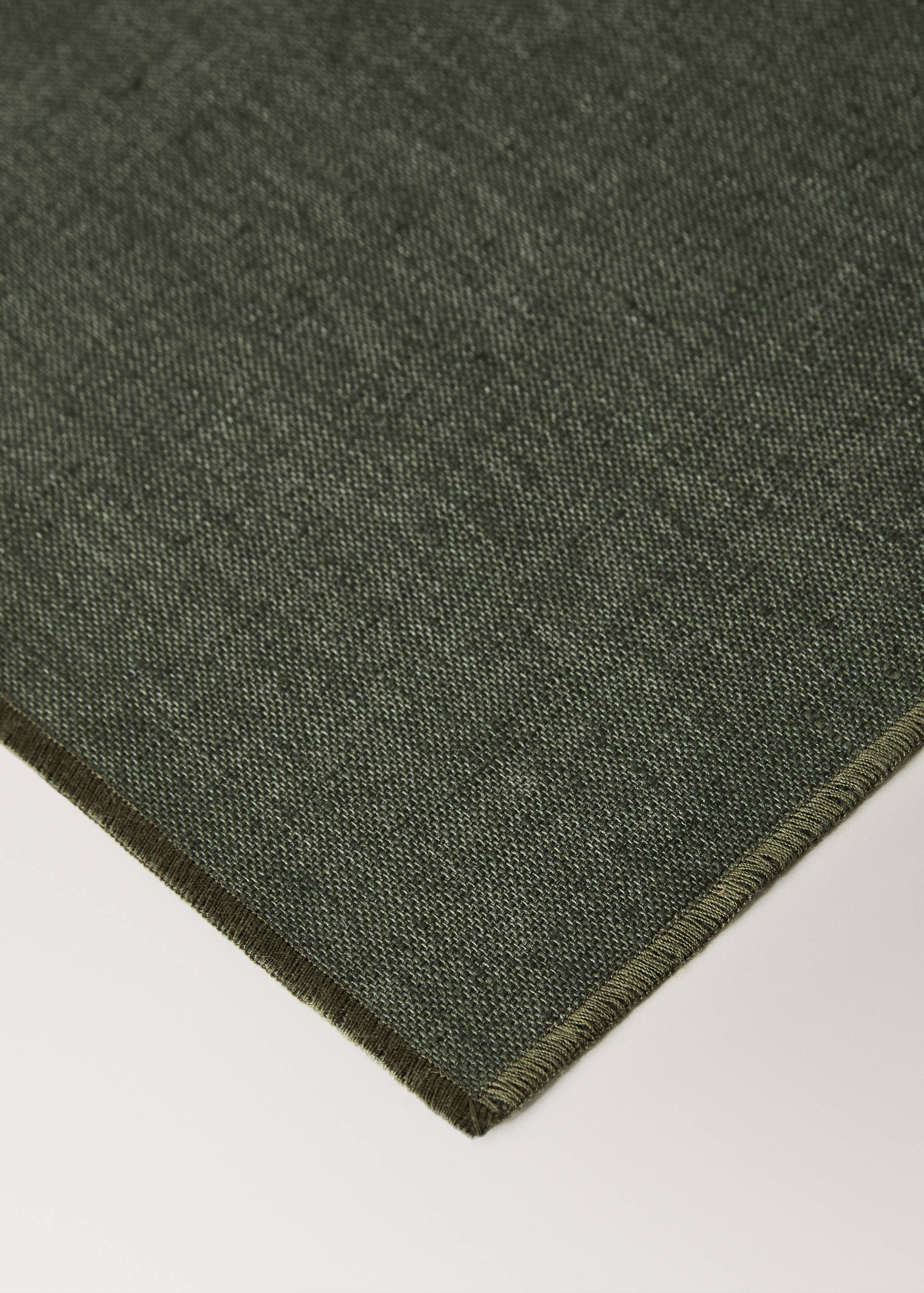 Dark green textured woven table mat with a neat border detail.