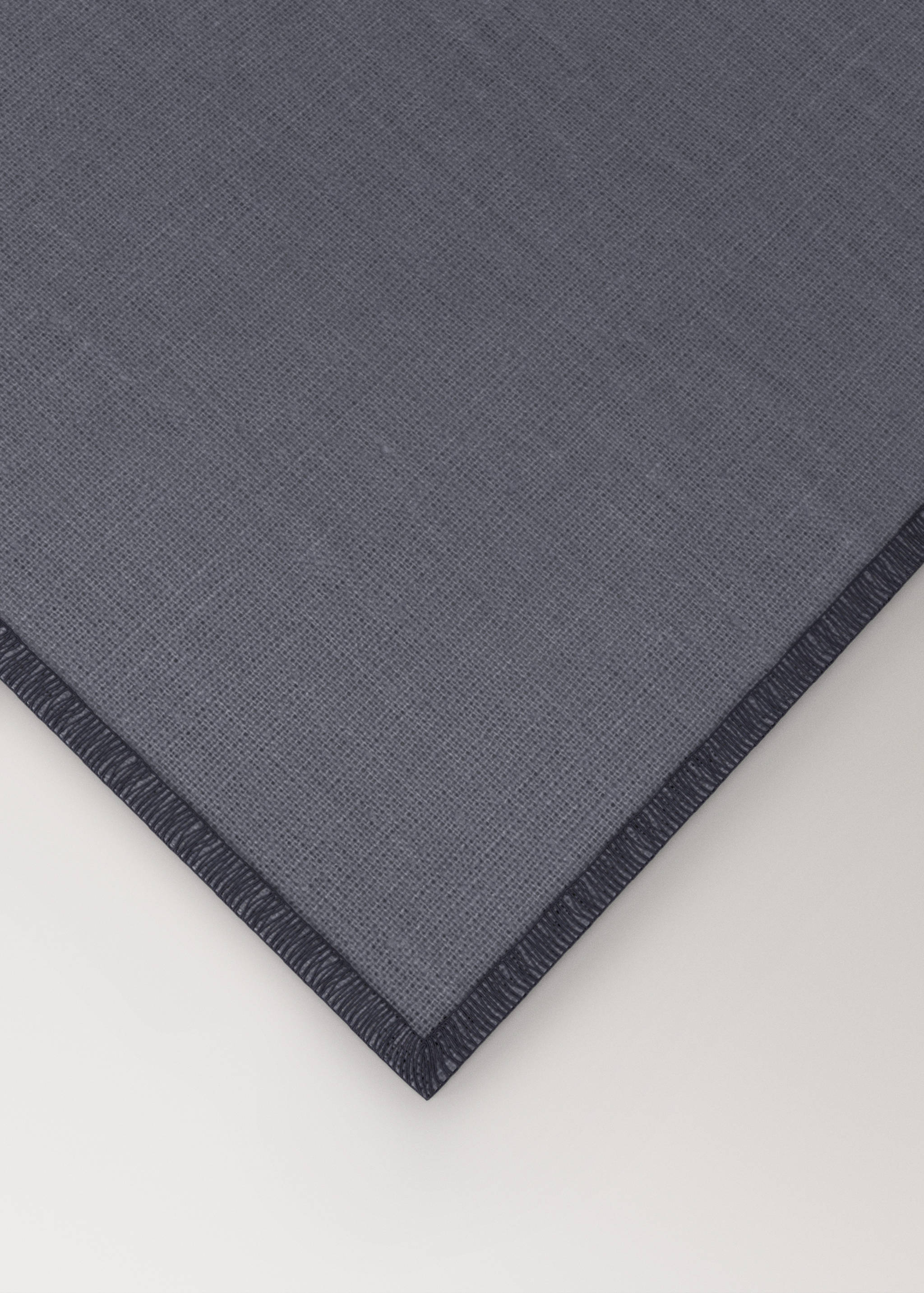 Dark blue placemat with textured fabric and stitched edge detail.