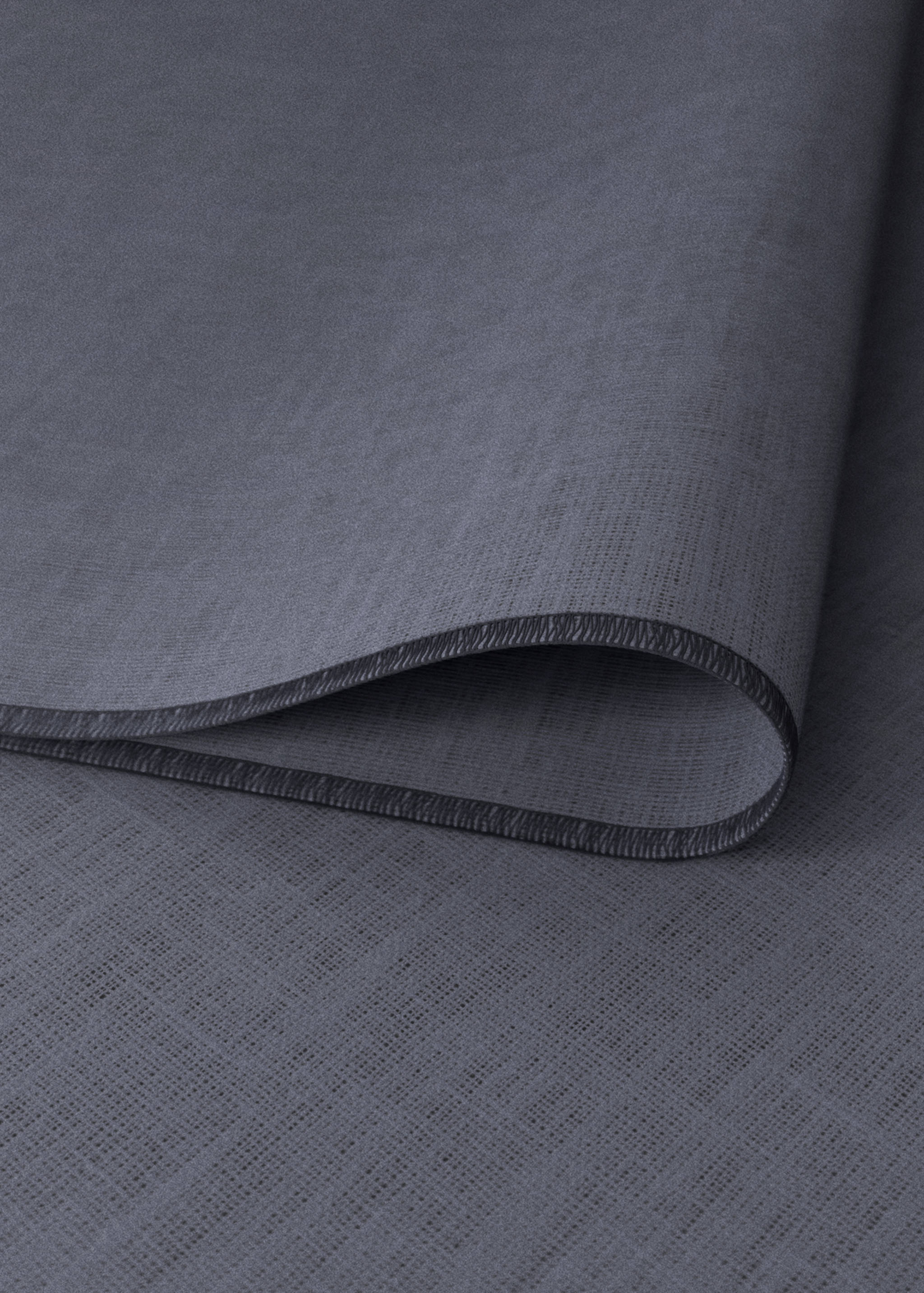 Grey placemat in a textured woven fabric with a bound edge.